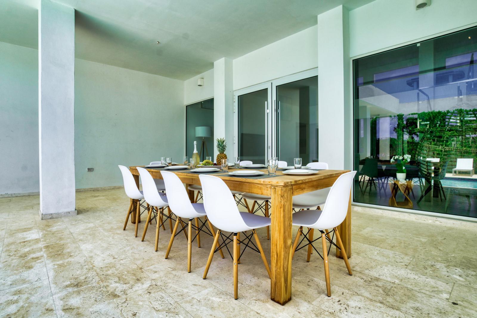 Regal outdoor Dining Area of the Villa in Noord Aruba - 10 Persons Dining - Unwind in our outdoor haven, where every meal is a breeze - Experience outdoor bliss with our charming dining - Stunning pool views