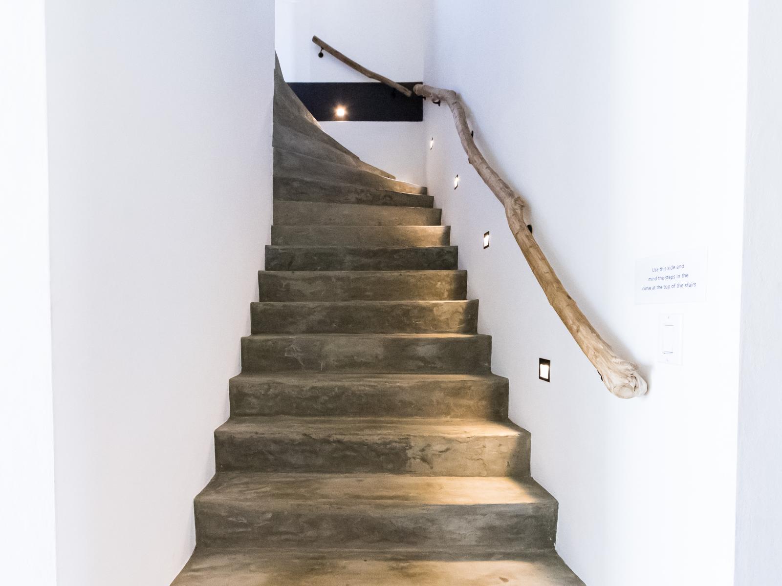 Elegant stairs lead gracefully to the second floor, seamlessly connecting the main level to the upper living spaces.