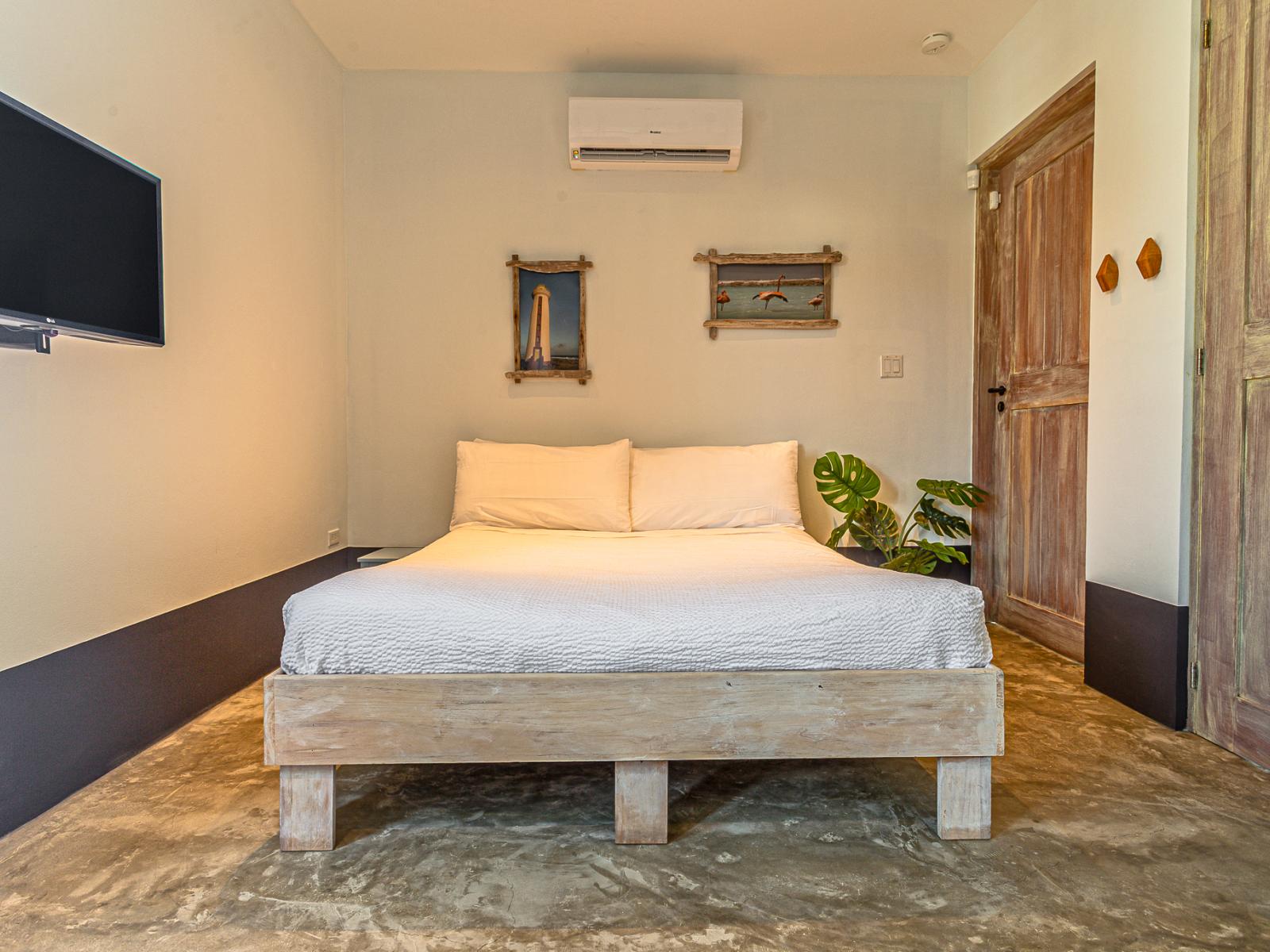 Bedroom 5 includes a Queen bed and a wall-mounted flat-screen TV, providing a cozy and well-equipped retreat.