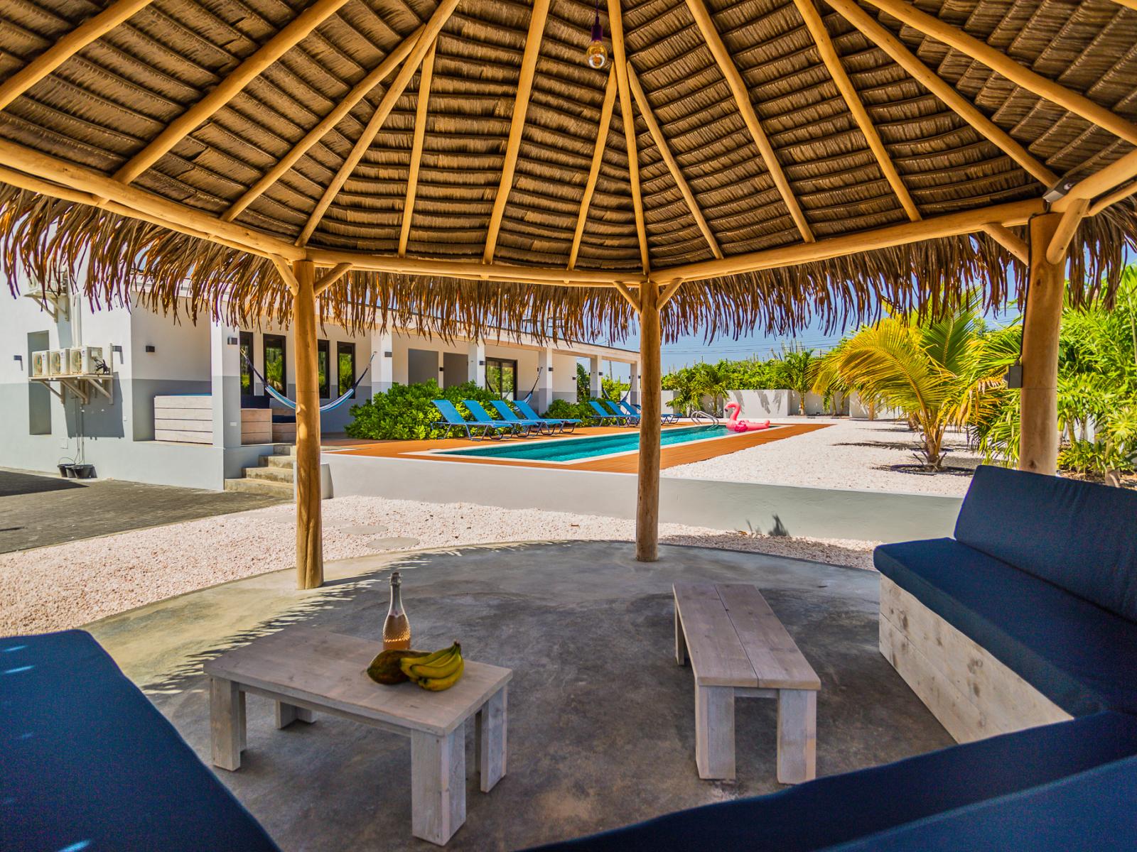 Be sure to pour yourself a drink and book some time underneath the thatched tiki pergola