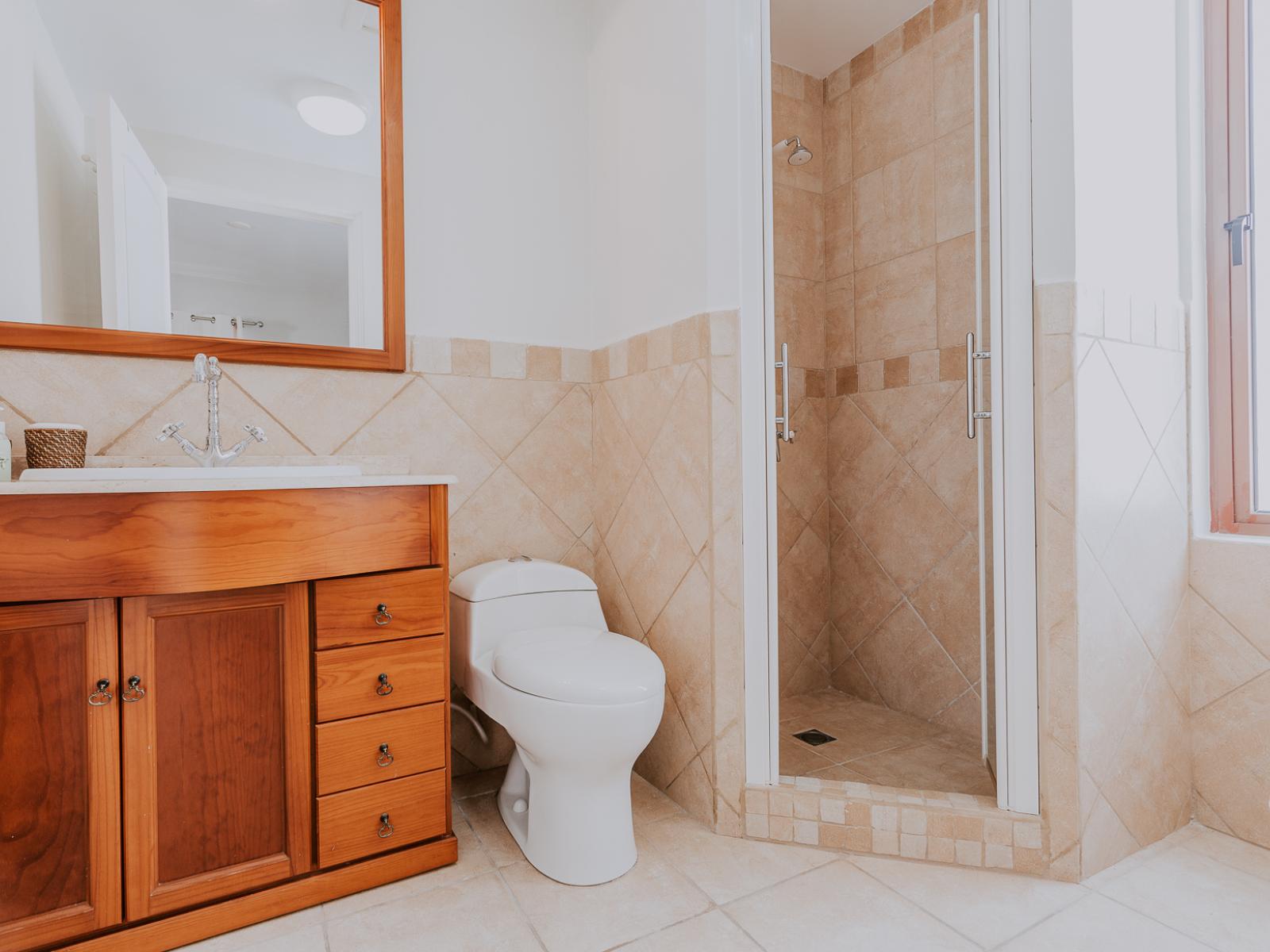 Experience luxury and convenience in Bathroom 2, accessible from Bedroom 2, featuring a spacious walk-in shower. With modern design and indulgent amenities, this ensuite provides a rejuvenating retreat to unwind and refresh in style.