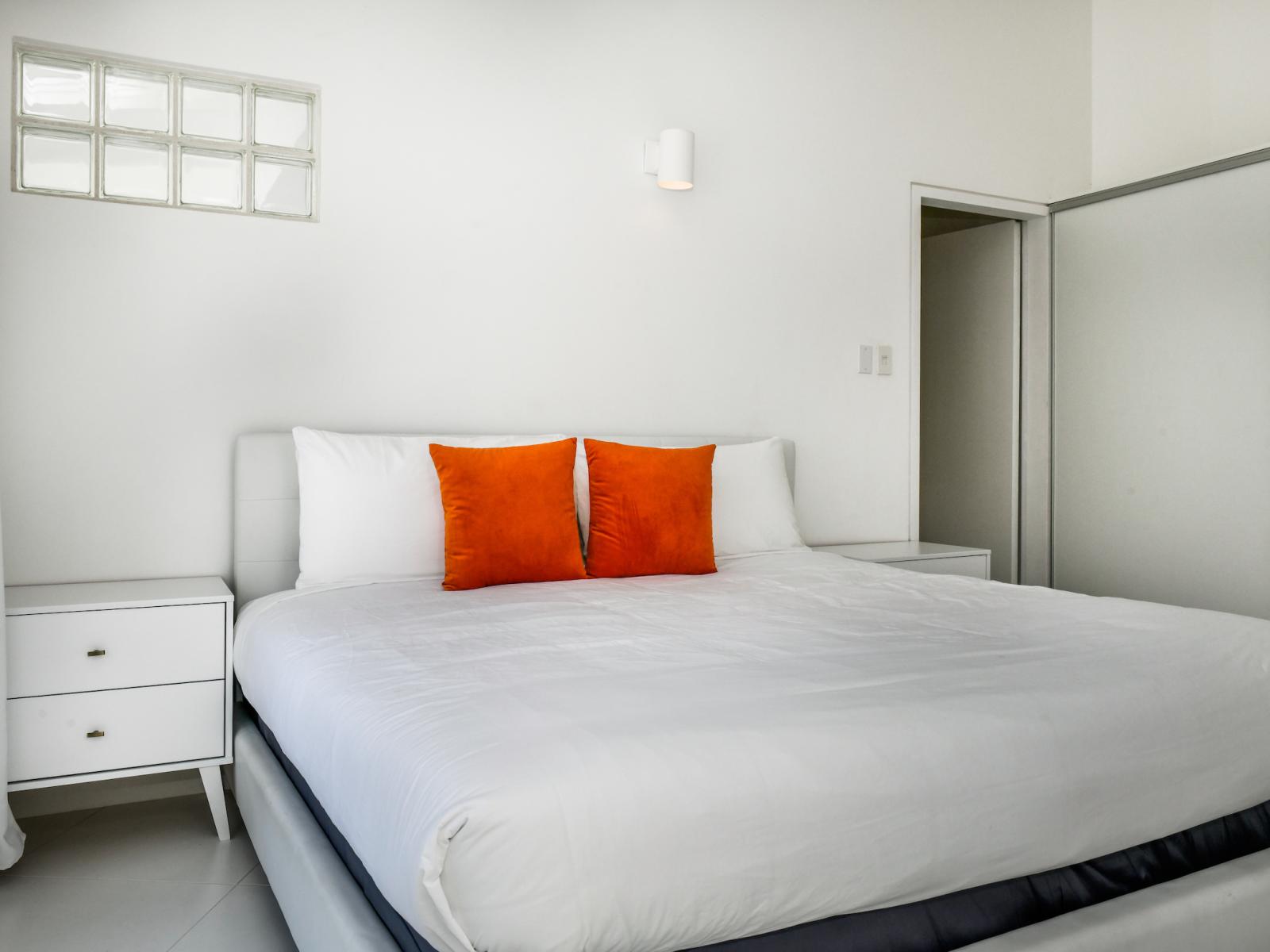 Retreat to luxury in our spacious bedroom, where a plush king bed, personal TV, and attached bathroom ensure the ultimate comfort and convenience.