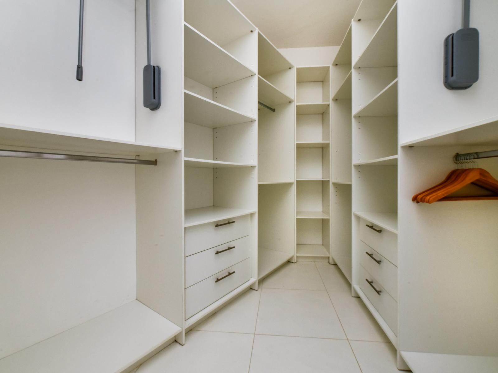 Step into organization and style with our walk-in closet, where ample space and smart storage solutions await to enhance your stay.