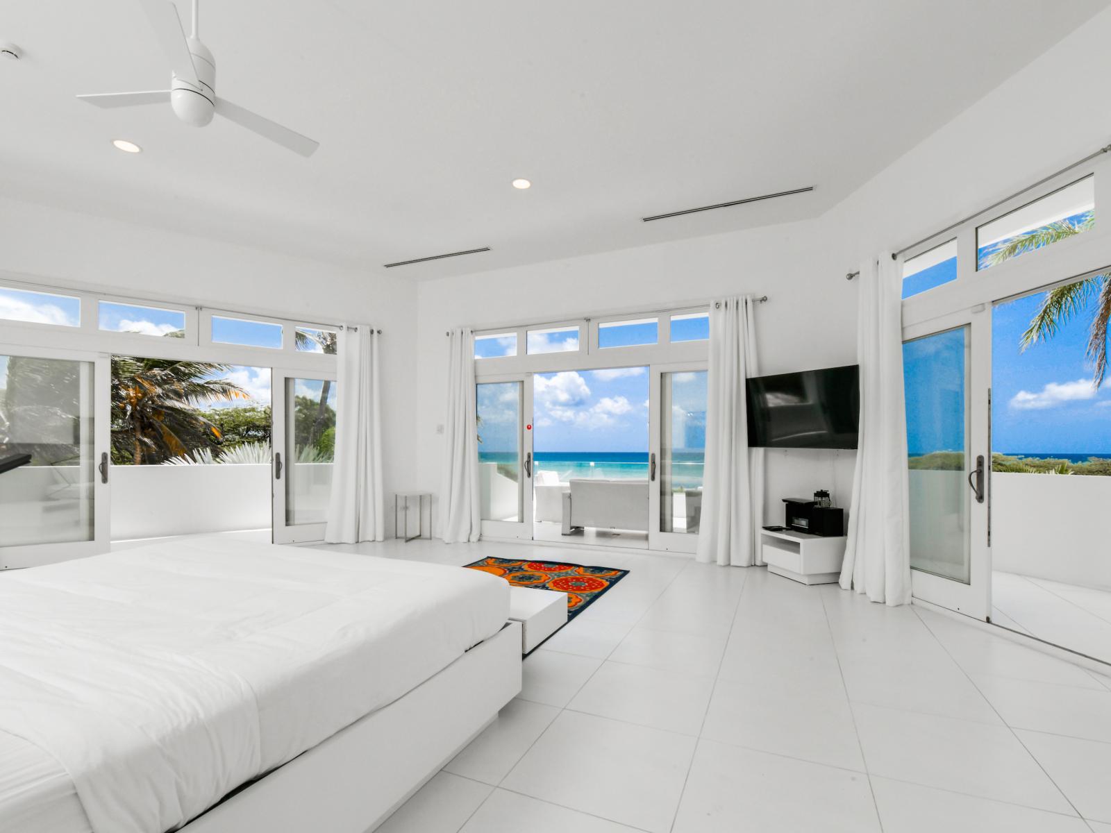 Escape to tranquility on the balcony of our main bedroom, where sweeping vistas and gentle breezes create the perfect backdrop for relaxation and reflection.