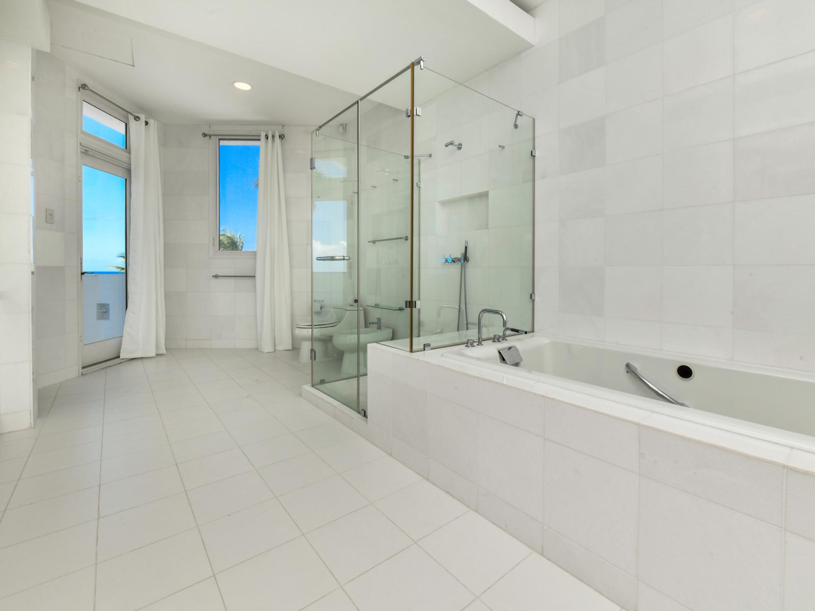 Experience the epitome of relaxation in our main bedroom's ensuite bathroom, offering a sumptuous bathtub where you can soak away your cares while enjoying stunning views of the ocean.