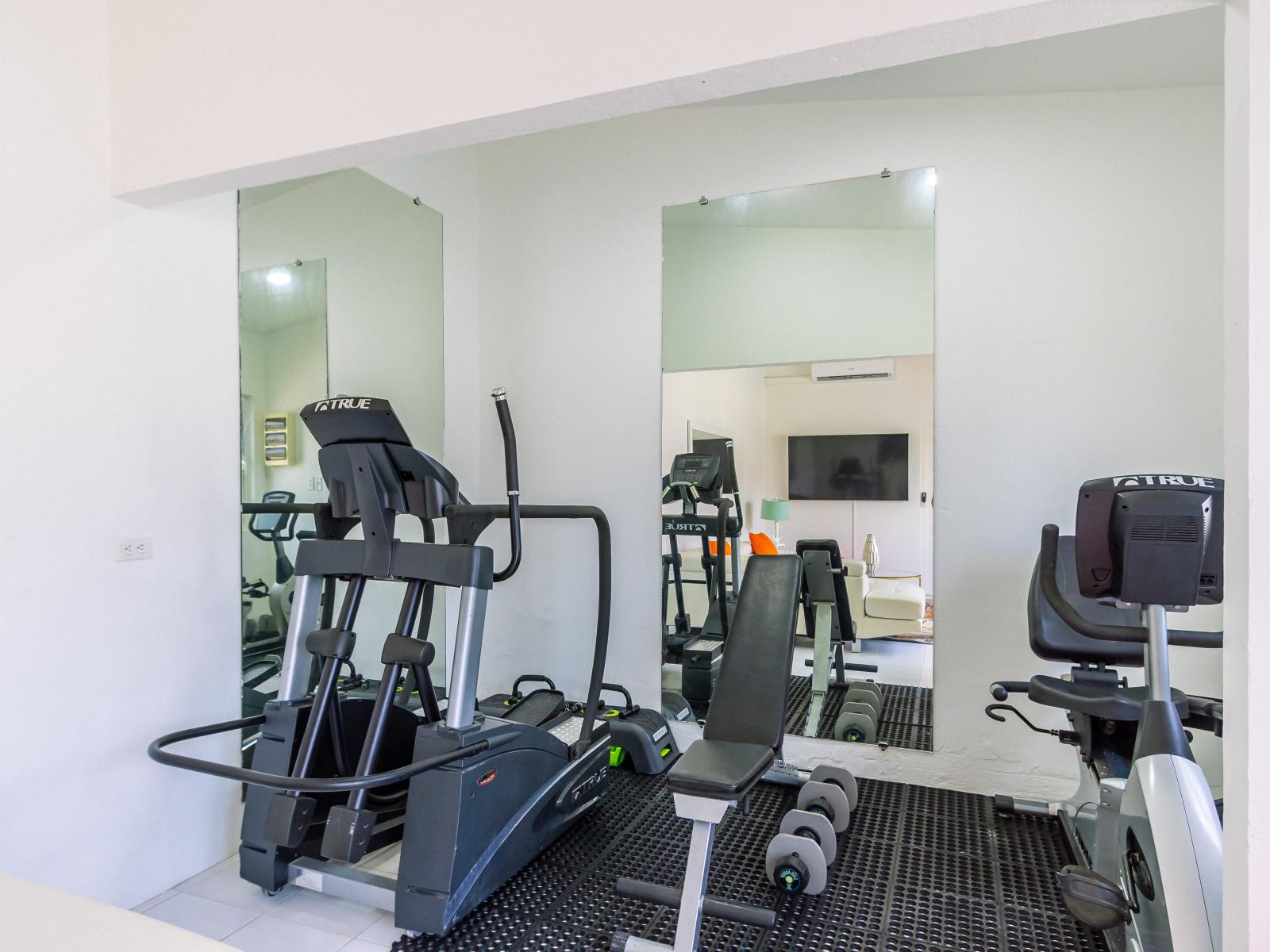 Empower your wellness journey in the comfort of our villa's gym, where state-of-the-art equipment and serene surroundings combine to elevate your fitness experience.