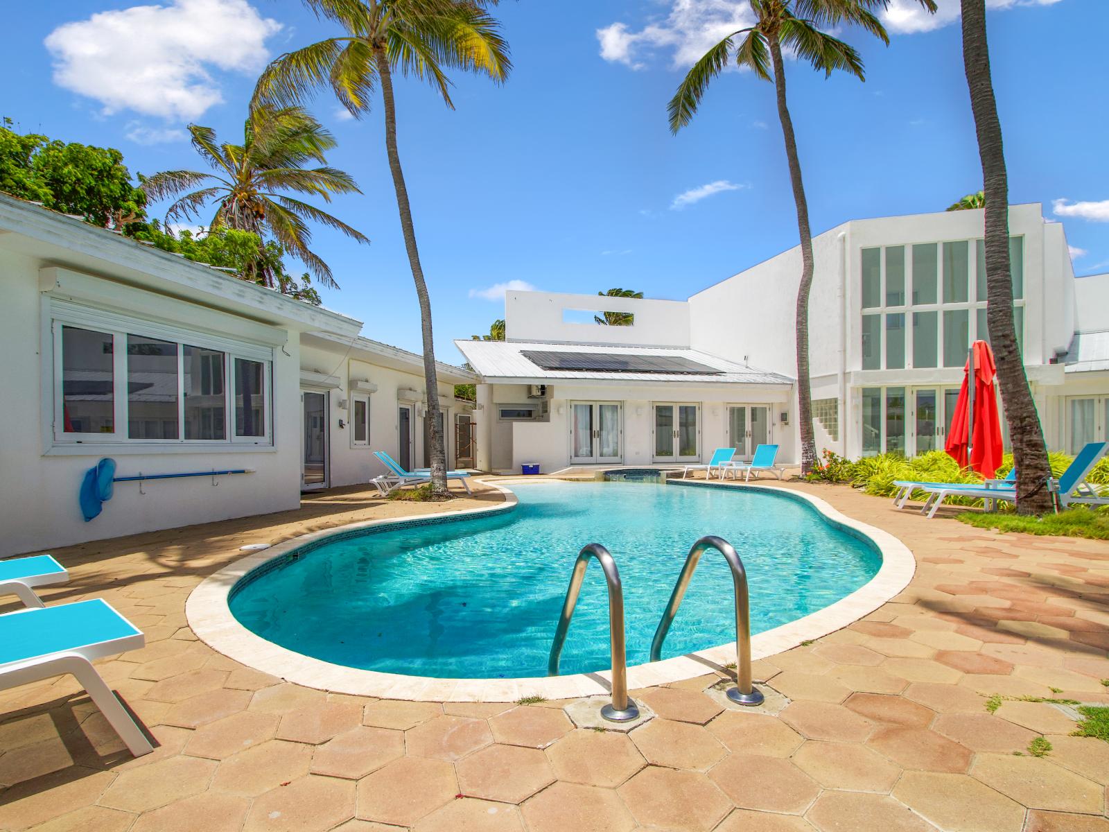 Luxury pool area of the Villa in Noord Aruba - Lush and refreshing environment - Cozy beach chairs available - Beautifully sunbathed space makes the soul peaceful - Experience the comfort at the best