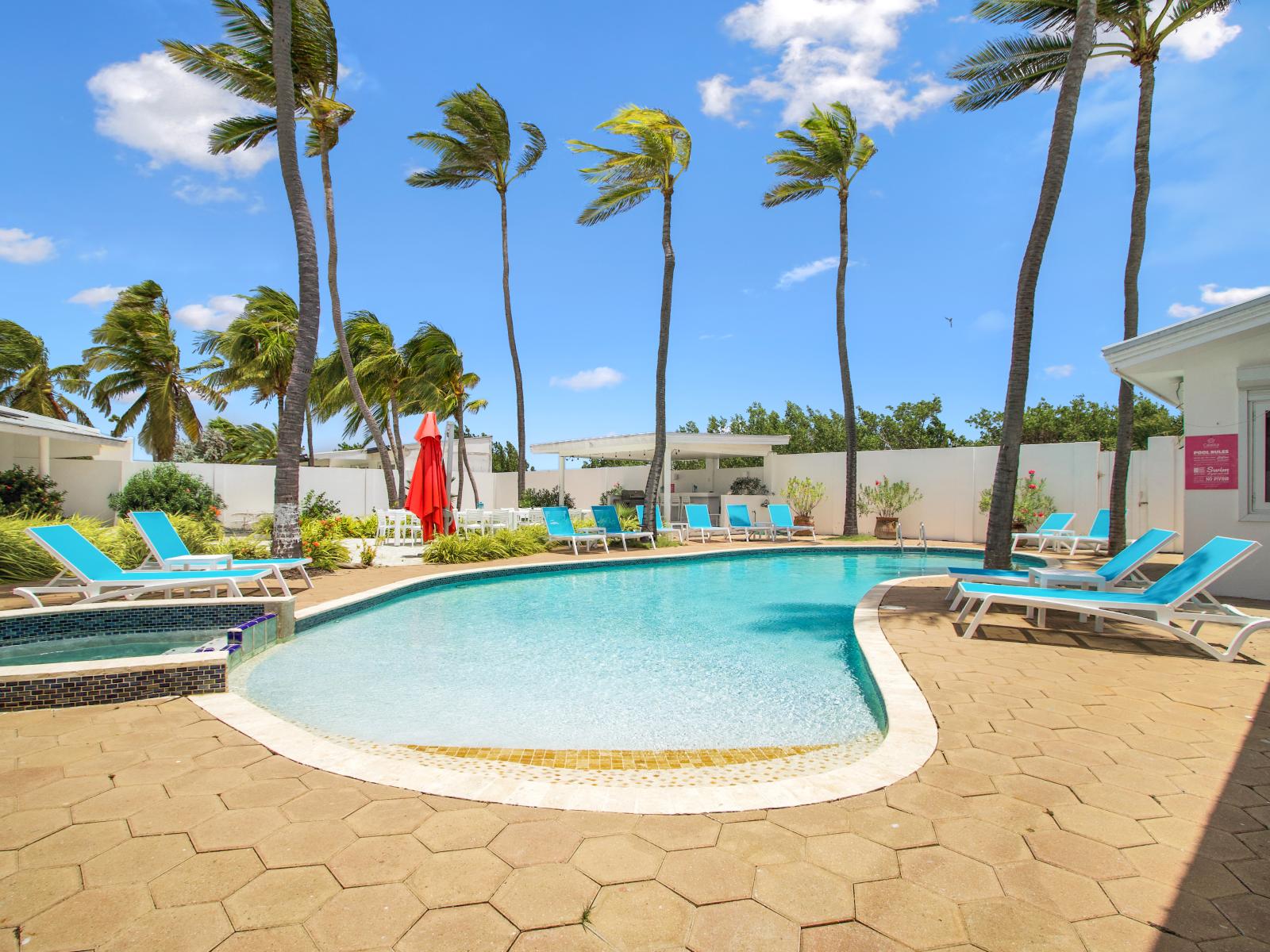 Indulge in relaxation, luxury, and endless blue vistas at our poolside haven. Dive into a world of tranquility just steps from your accommodation, where every moment is an escape into pure bliss. 🌊💫 #LuxuryRetreat #EndlessBlue