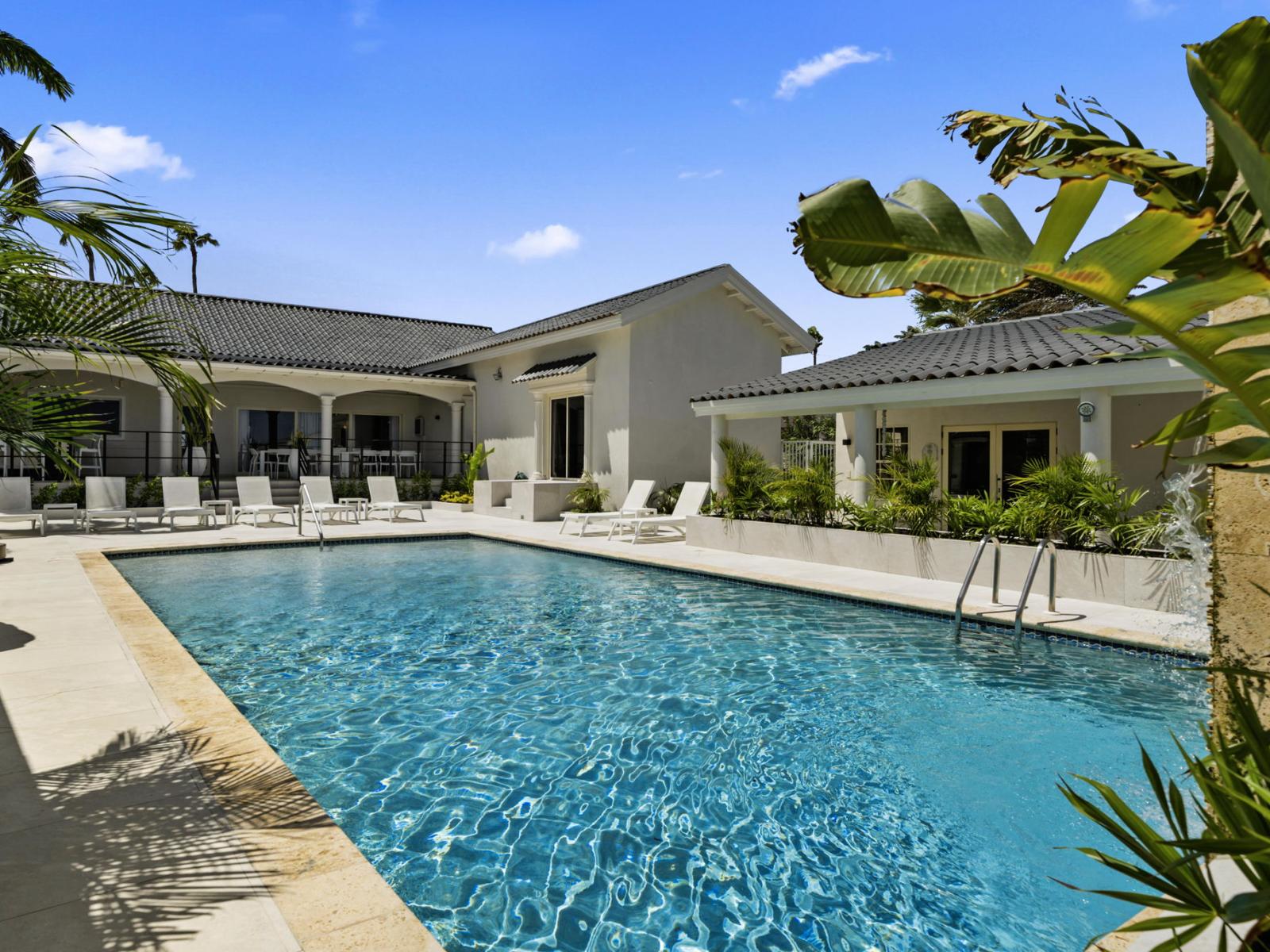 Dive into relaxation at our expansive pool, complete with ample seating options for soaking up the sun's rays.