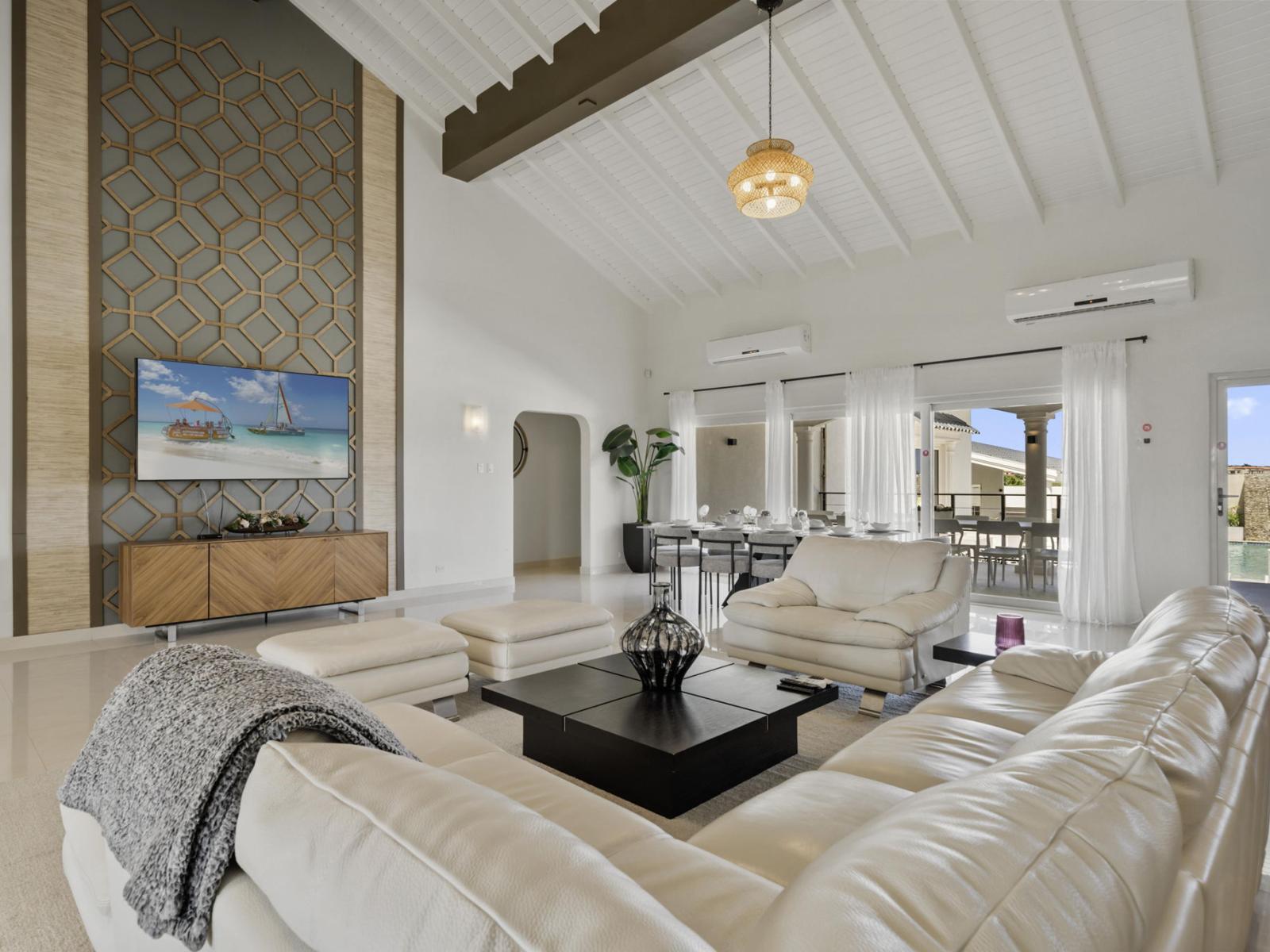 Step into our spacious living room, where soaring ceilings create an atmosphere of grandeur and elegance.