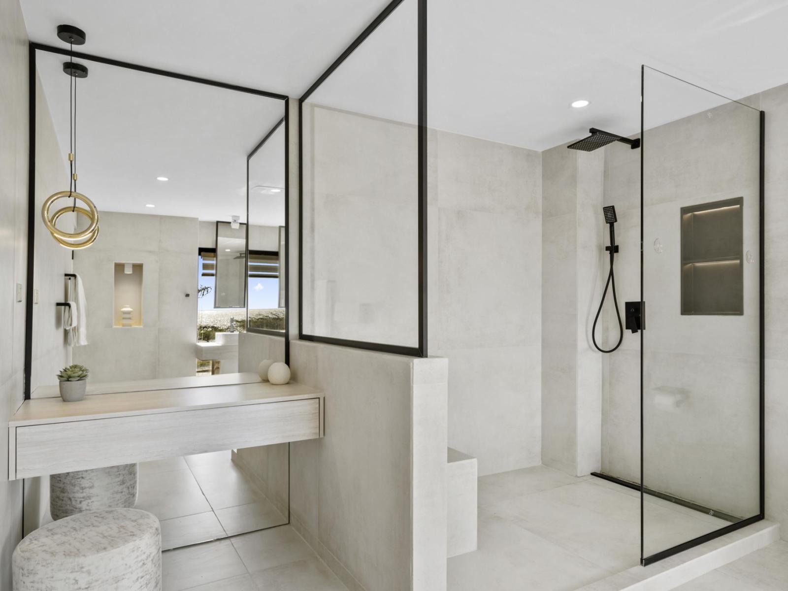 Elevate your self-care routine in our lavish ensuite bathroom, complete with a deluxe walk-in double shower and his-and-hers sinks, providing ample space and privacy for your daily rituals.