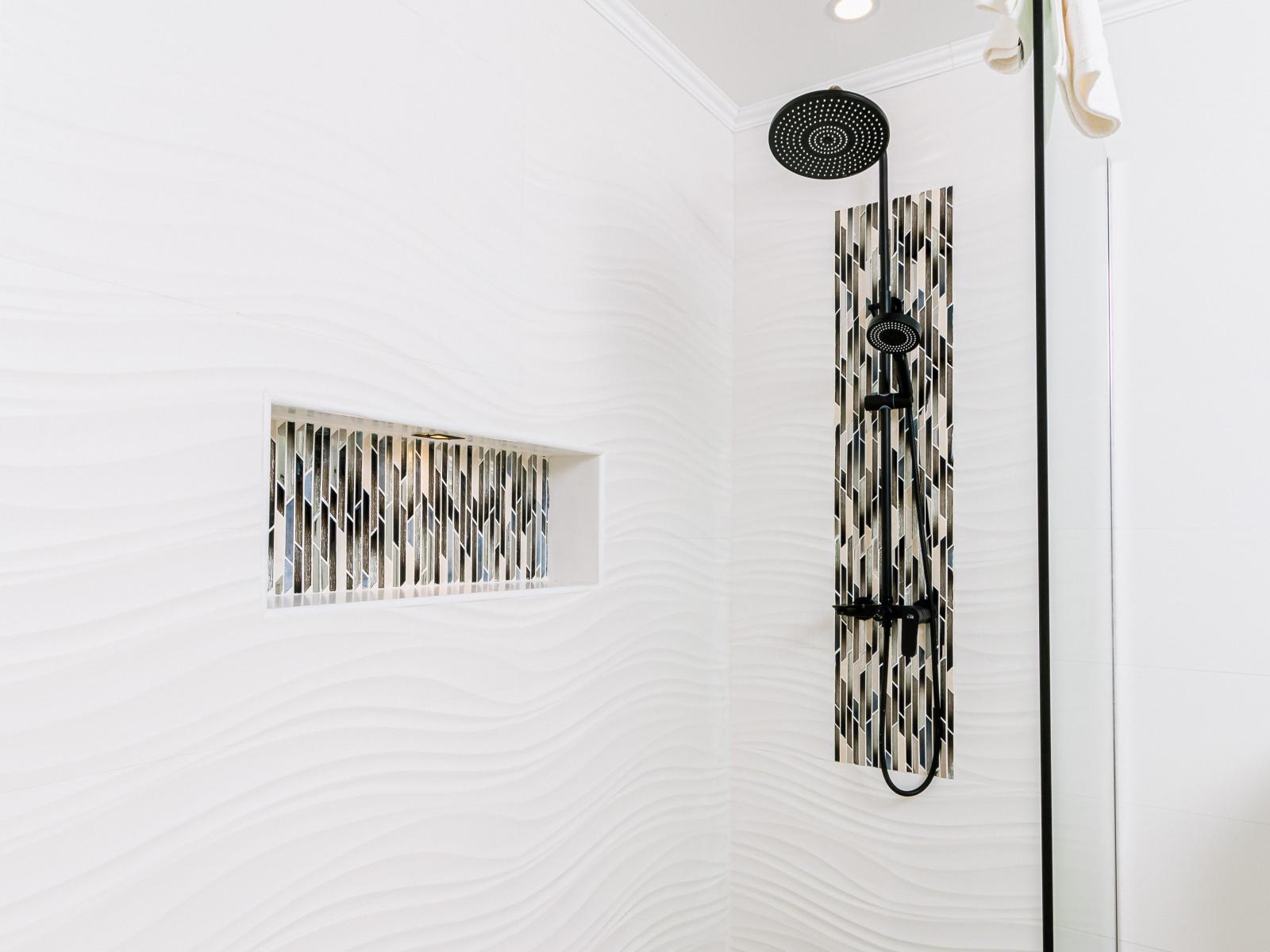 Step into luxury in our modern bathroom, featuring a spacious walk-in shower designed for ultimate relaxation and comfort. With sleek fixtures and elegant design, our shower provides a rejuvenating oasis where you can wash away the stresses of the day.