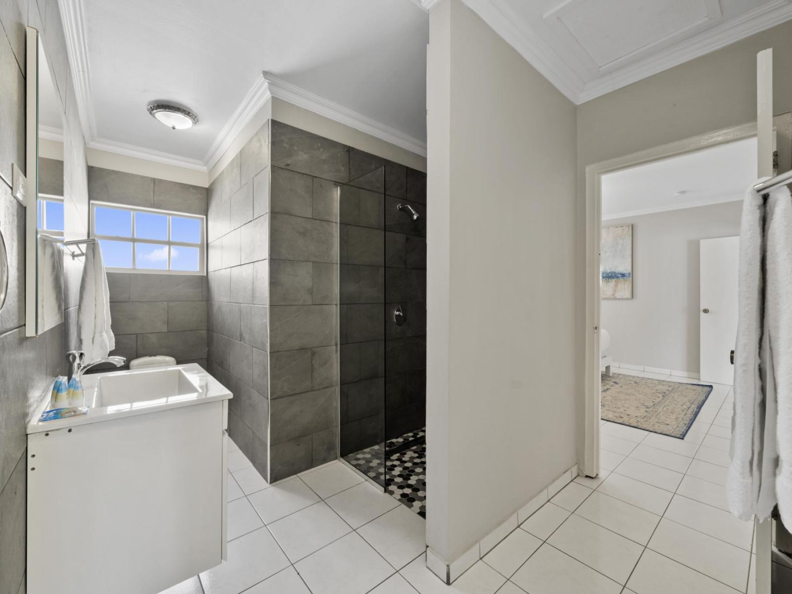 Indulge in the luxury of our ensuite bathroom, complete with a lavish walk-in shower. Designed for both comfort and convenience, this attached feature ensures a seamless experience, allowing you to unwind in style after a day of adventure or relaxation.