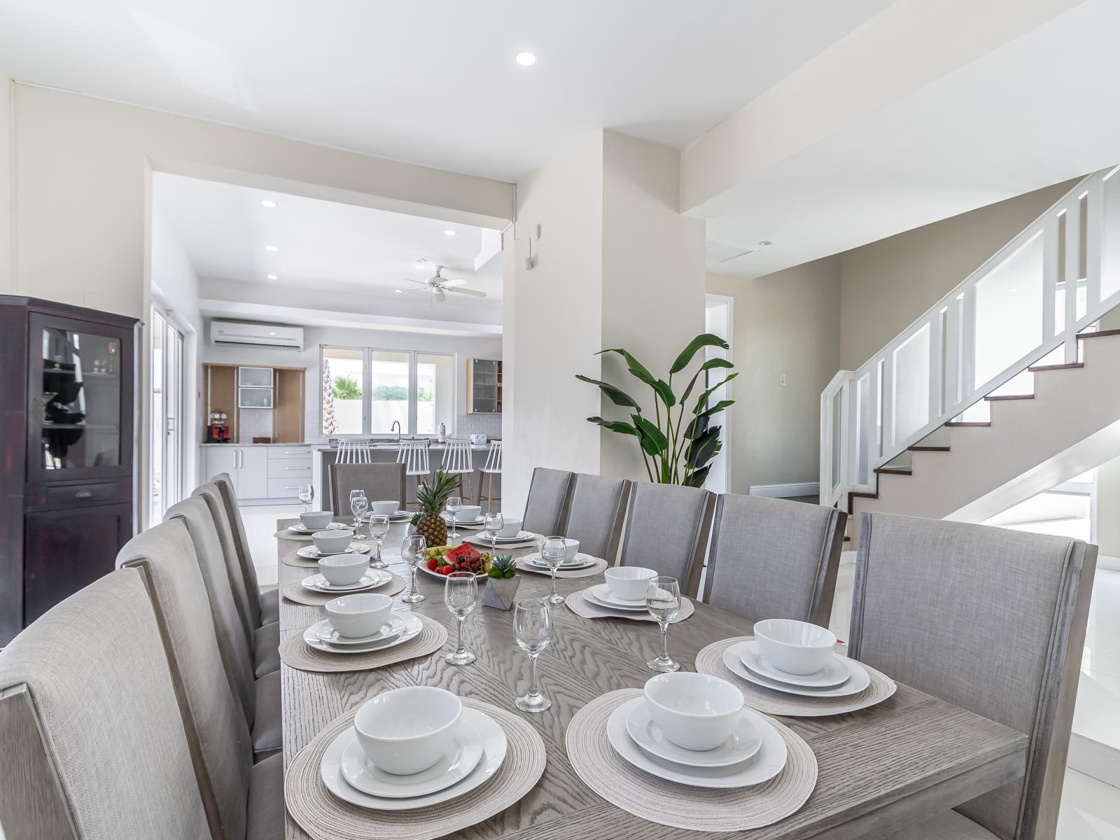 Indulge in dining luxury at the sleek and modern dining table of our villa, where every meal is an elegant affair amidst stylish surroundings.