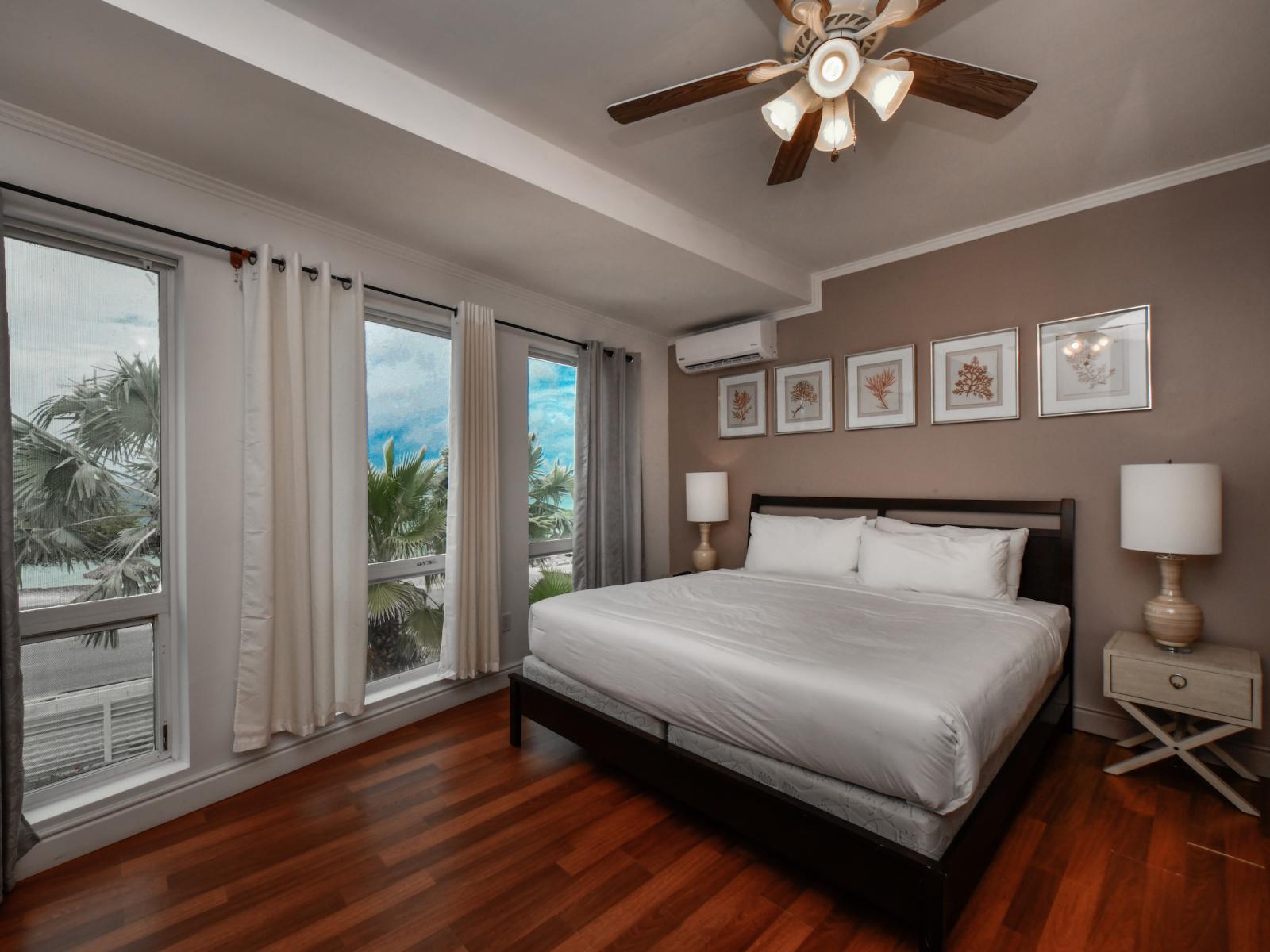 Revel in luxury in our ocean-view bedroom, boasting a king-sized bed, a TV for entertainment, and breathtaking views of the ocean, ensuring a serene and unforgettable stay.