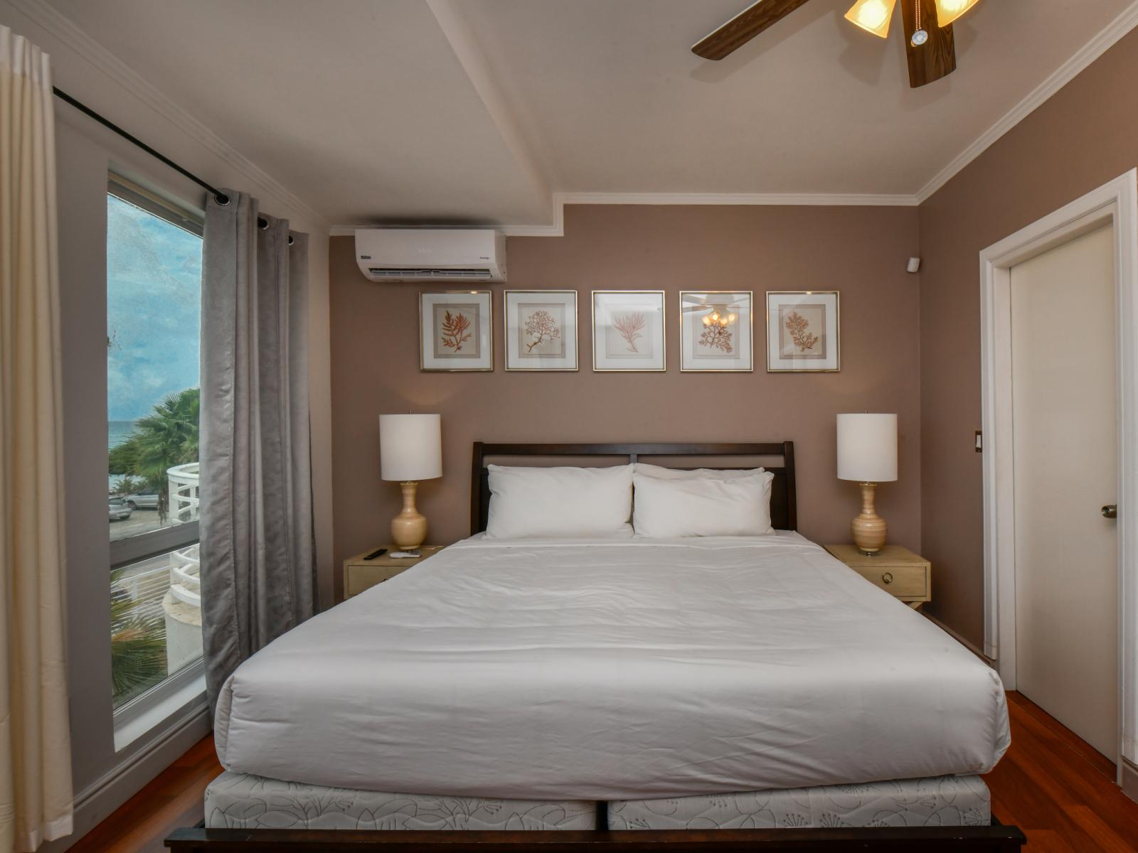 Experience the epitome of relaxation in our ocean-view bedroom, featuring a king-sized bed, a TV for entertainment, and stunning vistas of the ocean, creating the perfect ambiance for a tranquil retreat.