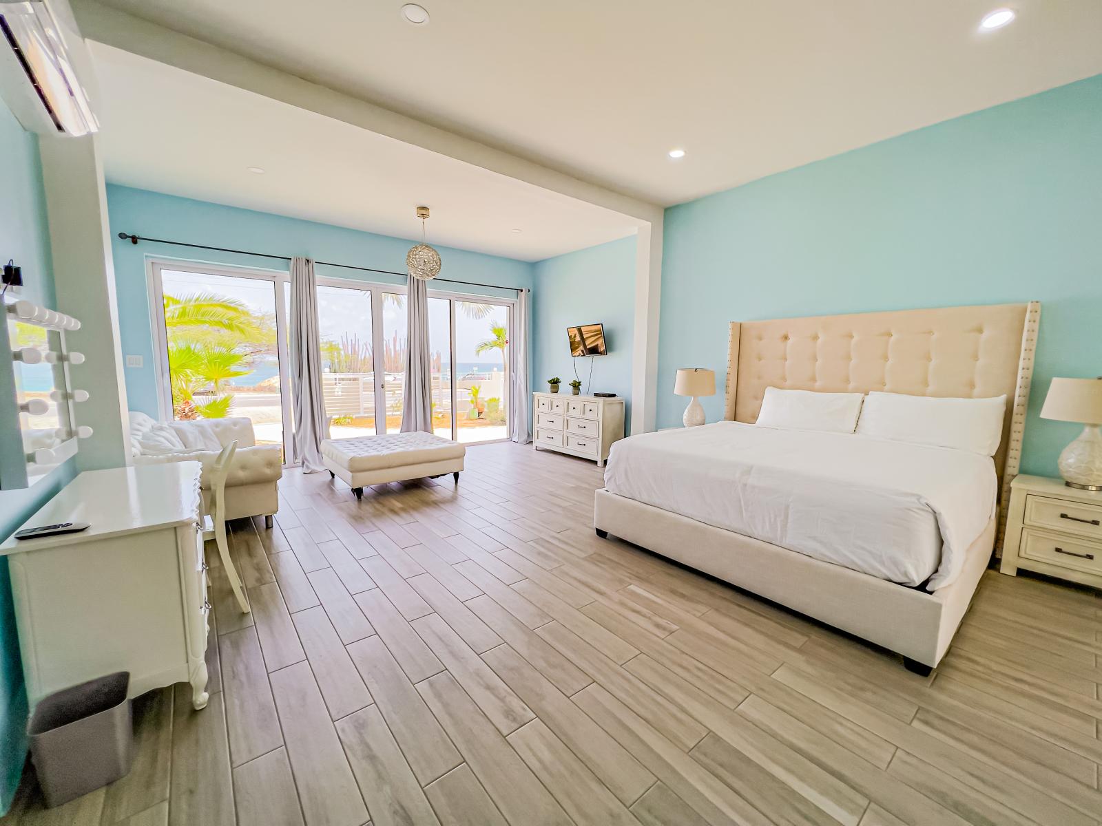 Unwind in luxury in our ocean-view bedroom, offering a king-sized bed, a TV for entertainment, and mesmerizing vistas of the ocean, providing a serene and rejuvenating escape.