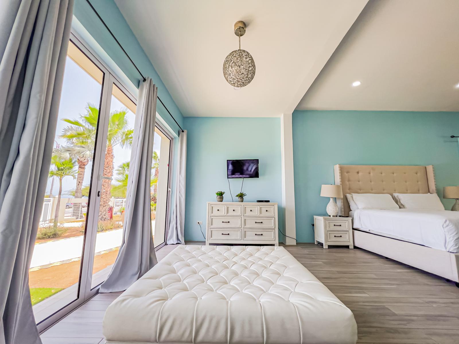 Indulge in relaxation with our bedroom lounge area, offering a TV and breathtaking ocean views, creating the perfect sanctuary for unwinding and soaking in the coastal charm.