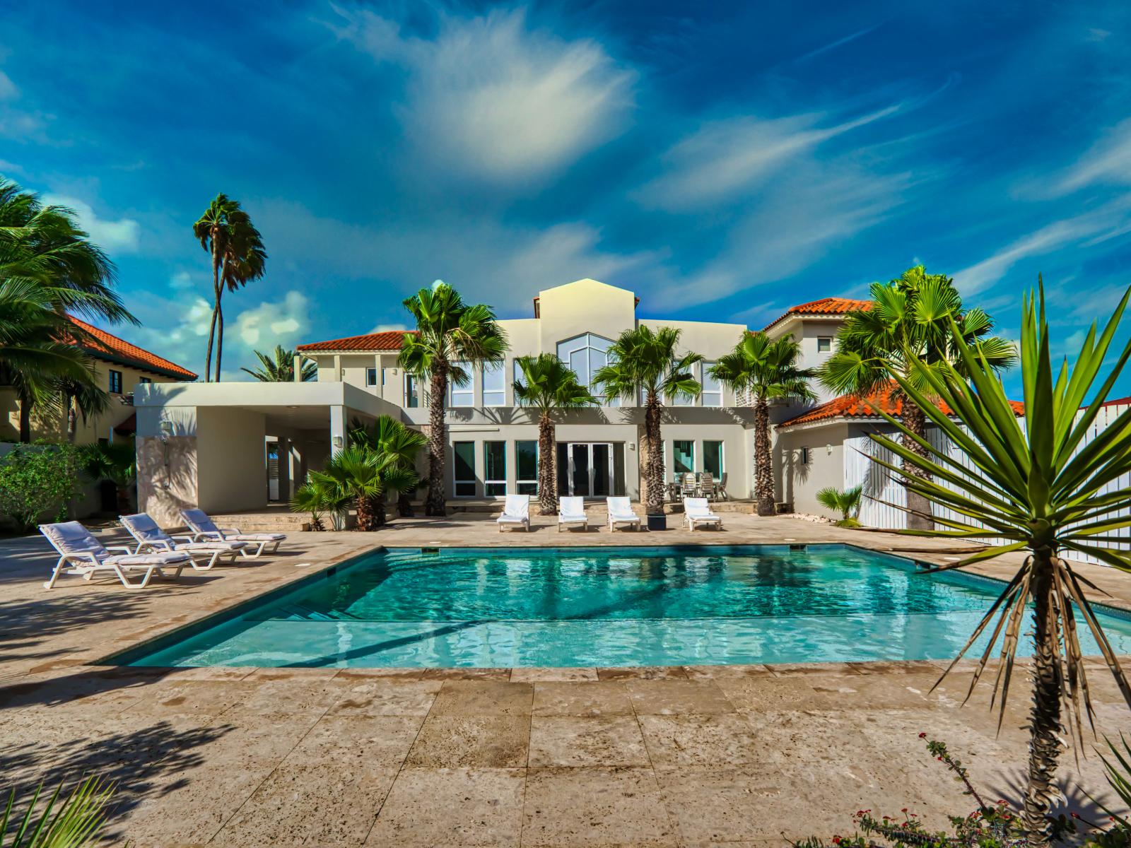 Large refreshing pool with chairs to lounge in the sun