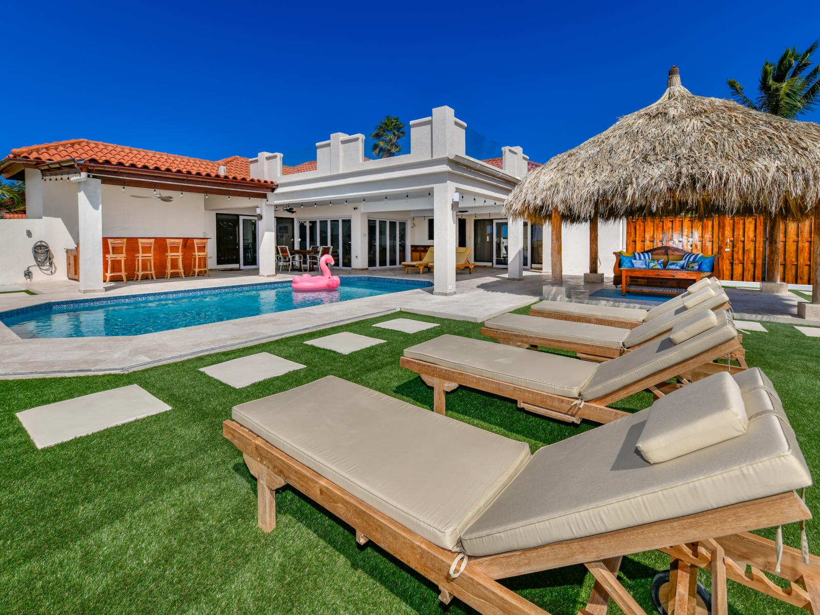 Lavish Pool Area of the 3BR House in Noord Aruba -  Comfortable lounge chairs for ultimate relaxation - Refreshing Area - Sleek and stylish pool deck design