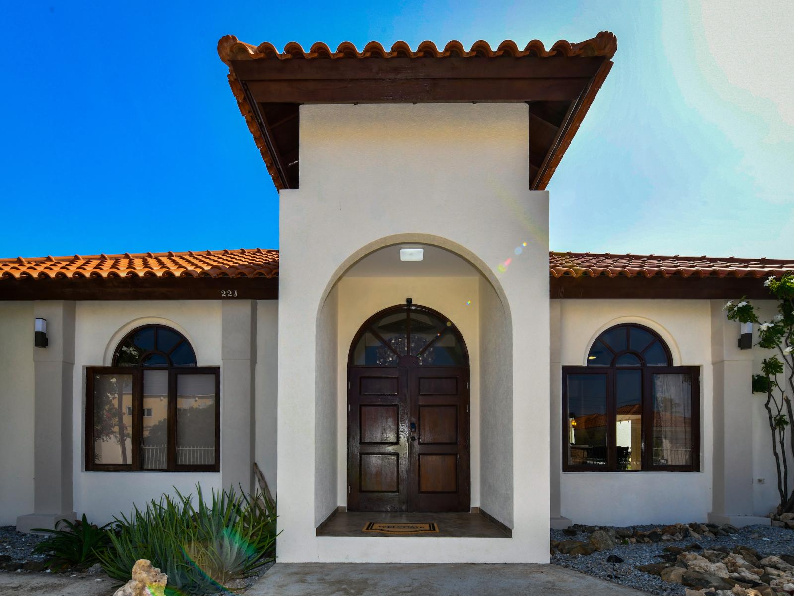 Inviting Entrance Area of the 3BR House in Noord Aruba - Spacious entrance gate. - Breathe fresh air with our thoughtfully placed green companions