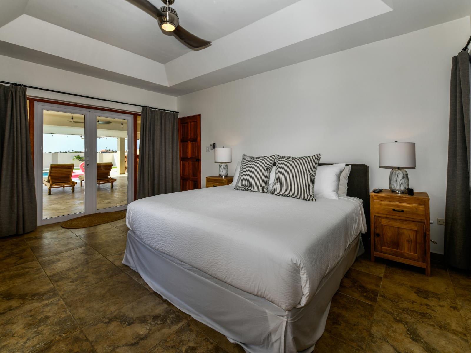 Regnant Bedroom of the 3BR House in Noord Aruba - Cozy retreat with a plush king size bed, perfect for relaxation - Access to Outdoor area - Tranquil bedroom retreat for restful nights