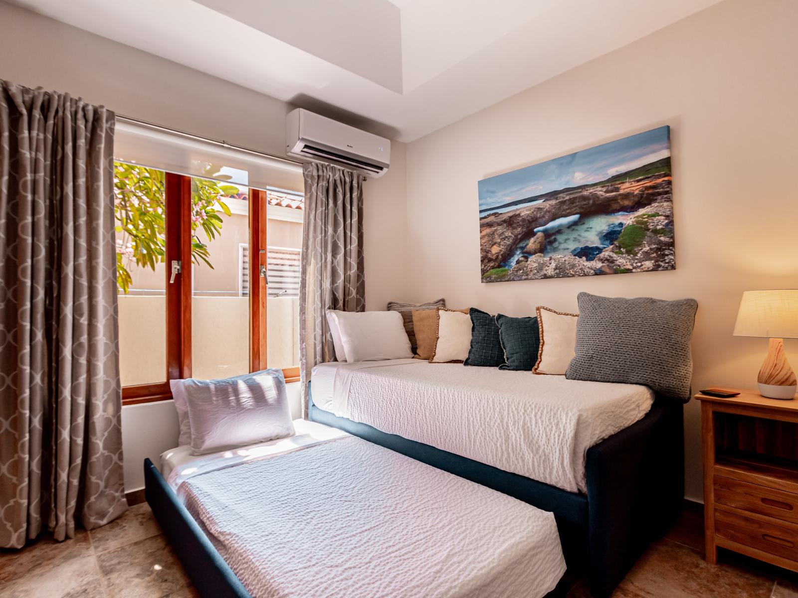 Lofty Bedroom of the 3BR House in Noord Aruba - Smart use of space - Minimalist decor, creating a clean and uncluttered sleeping space - Comfy beds