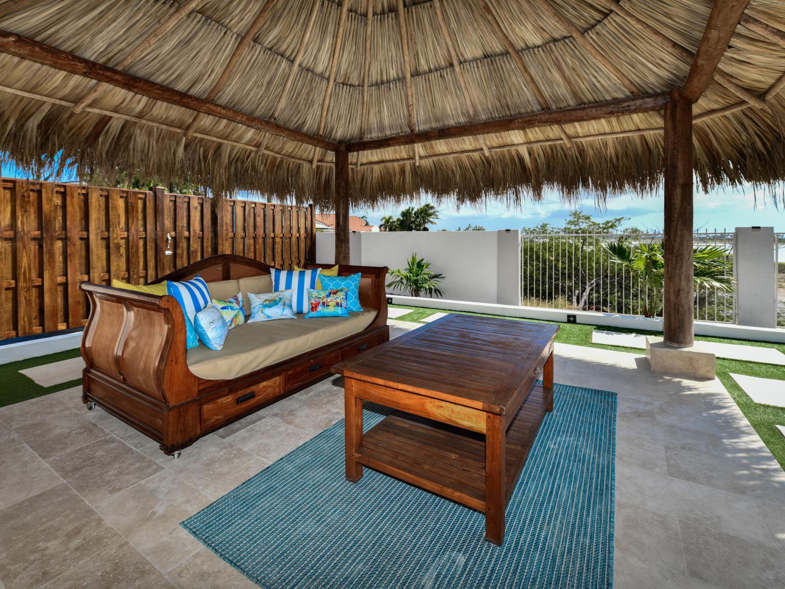 Outdoor lounge furniture under the tiki hut