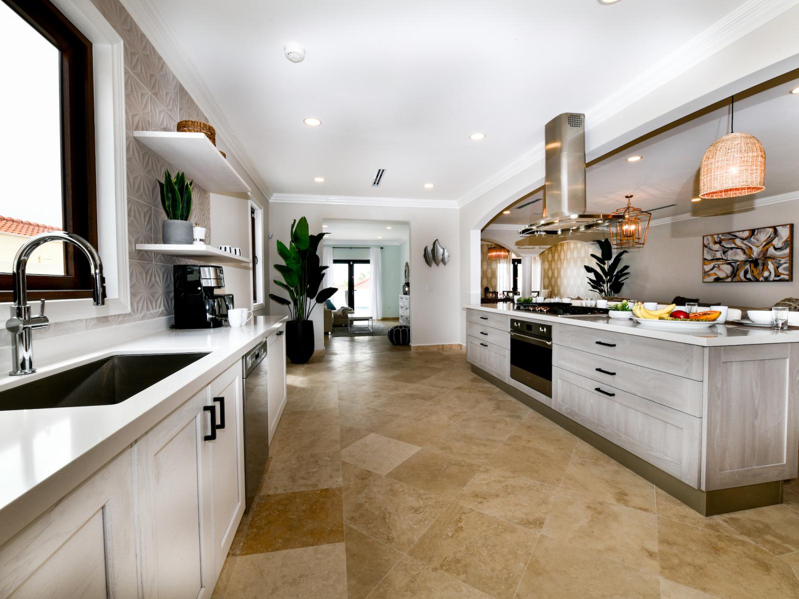 Spacious Kitchen Area of the Villa in Noord Aruba - Modern kitchen with sleek, stainless steel appliances - Contemporary design with clean lines and minimalist aesthetics - Smart use of space with versatile storage solutions