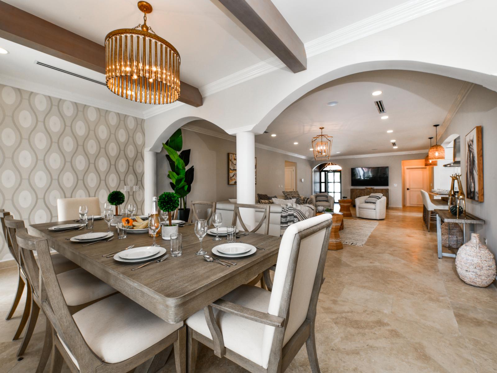 Exquisite Living and Dining Area of the Villa in Noord Aruba - Spacious open-plan design for a modern feel. - Ample natural light through large windows - Plush and comfortable seating arrangements - Entertainment hub with a Smart TV