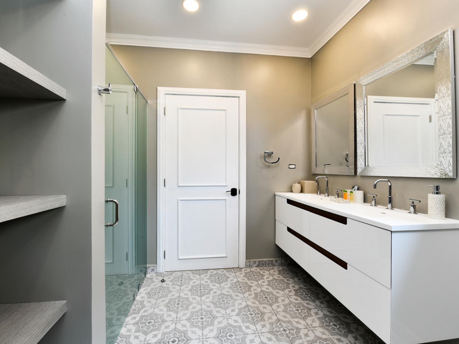 Lavish Bathroom of the Villa in Noord Aruba - Neat and Clean - Spacious layout offering a sense of luxury and comfort - Polished Vanity with Large Mirror - Walk-in shower Area