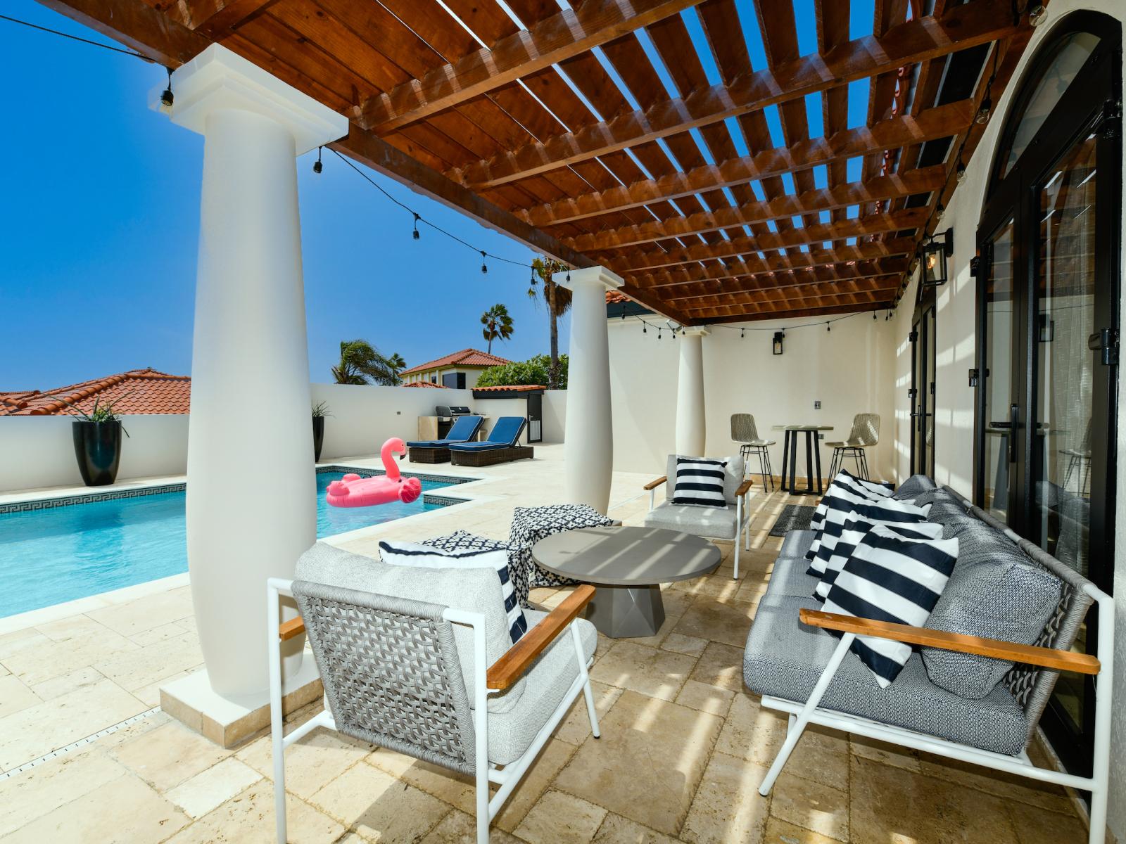 Palatial Pool Area of the Villa in Noord Aruba - Shaded lounge options by the pool - Pleasant Atmosphere - Comfy seating