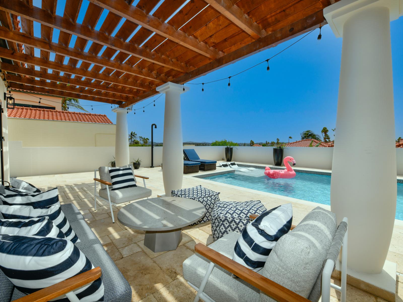 Pleasant Pool Area of the villa in Noord Aruba - Comfortable lounge chairs by the pool - Shaded seating - Plenty of space for every one