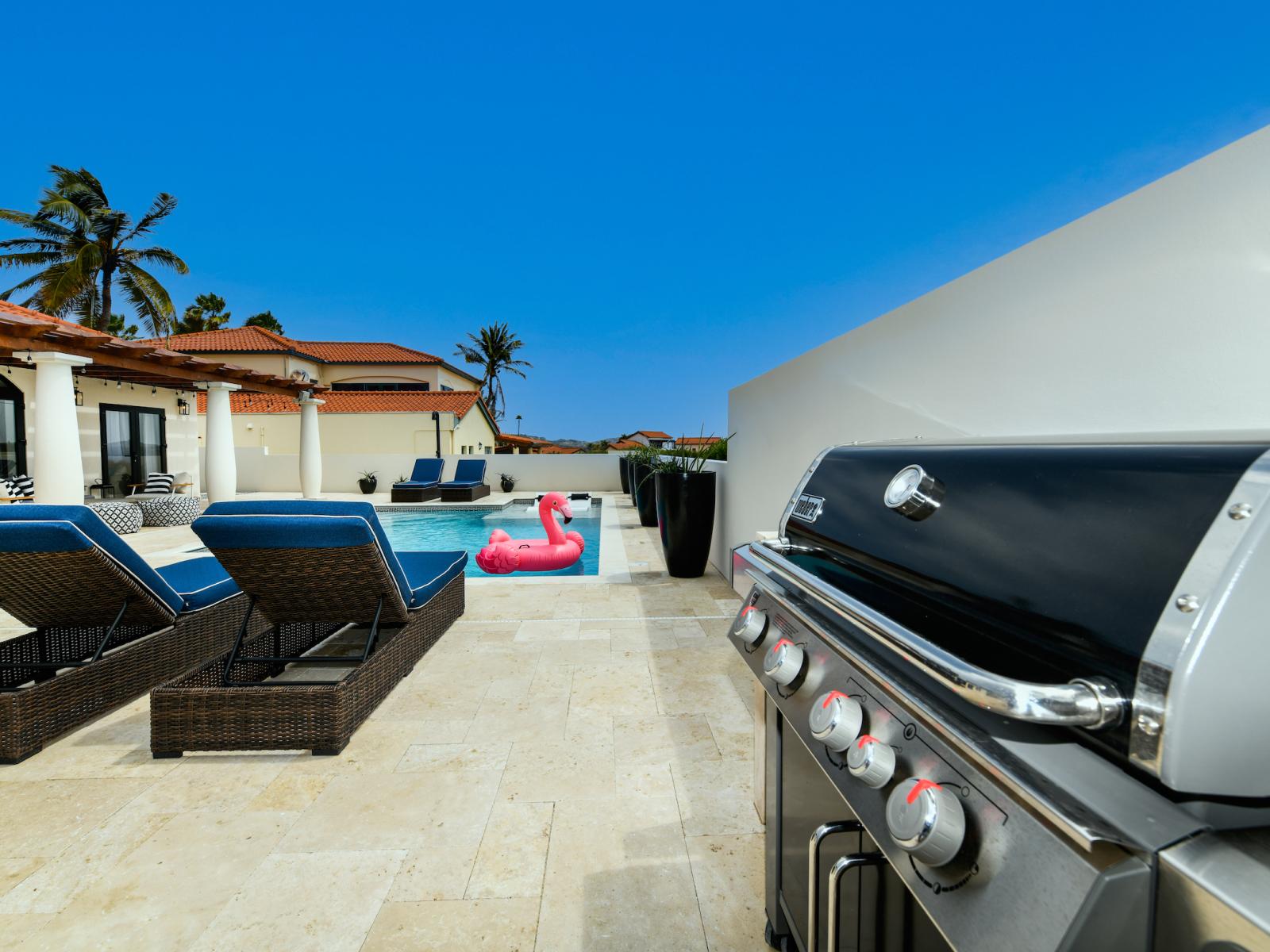 Refreshing pool of the Villa in Noord Aruba - BBQ Grill Outside - With lounge chairs in the water for ultimate relaxation - Relax by the shimmering poolside oasis - Crystal-clear water