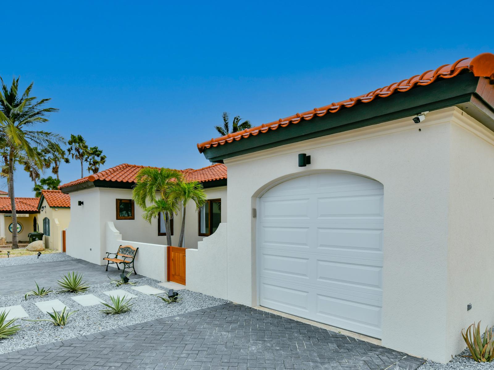 Captivating Villa in Noord Aruba - Garage at the front of the villa - Artfully arranged plants introduce freshness and visual interest - Peaceful environment