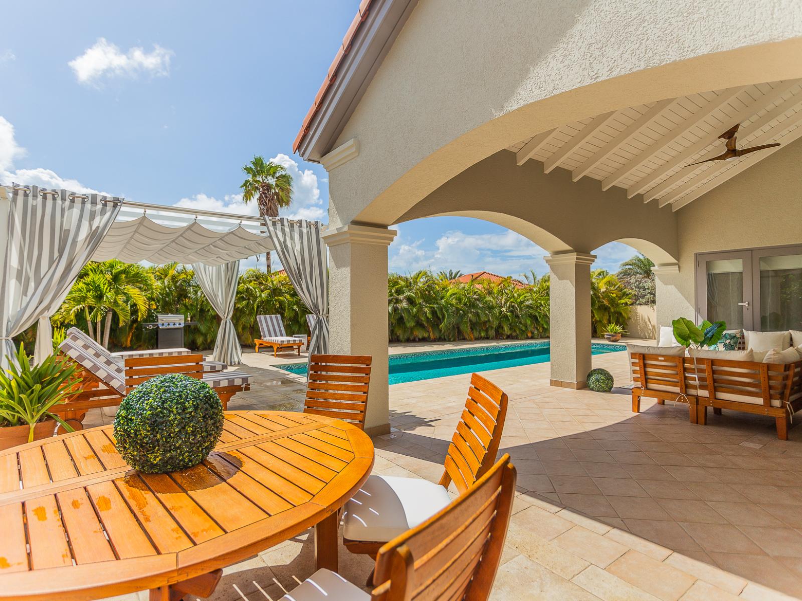 Refreshing Outdoor dining area of the Villa in Aruba  - Near Pool Area - Extended living space for outdoor enjoyment - BBQ Grill - Surrounded with greenery