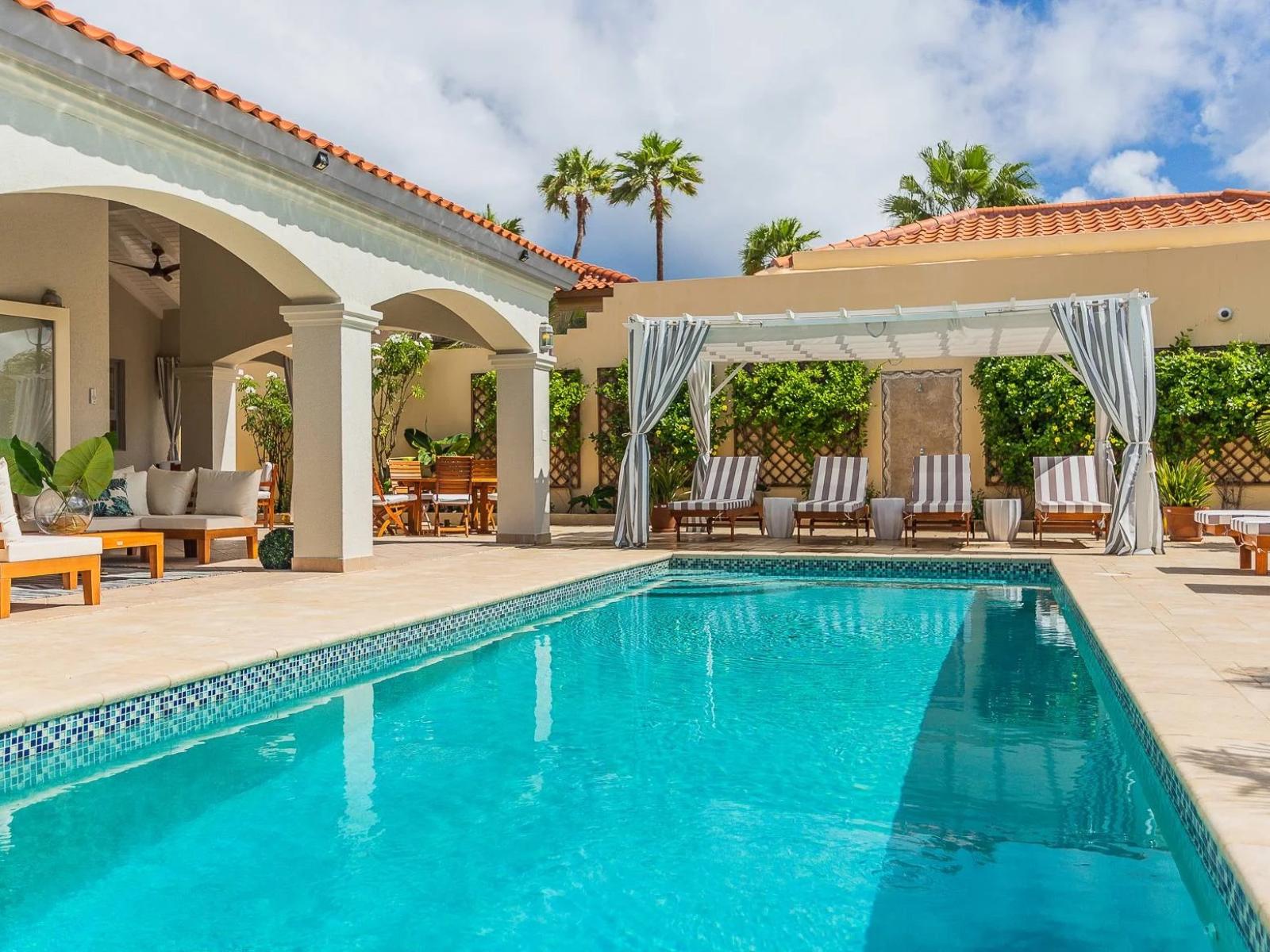 Private pool with a cabana and lounge chairs for ultimate relaxation and comfort.