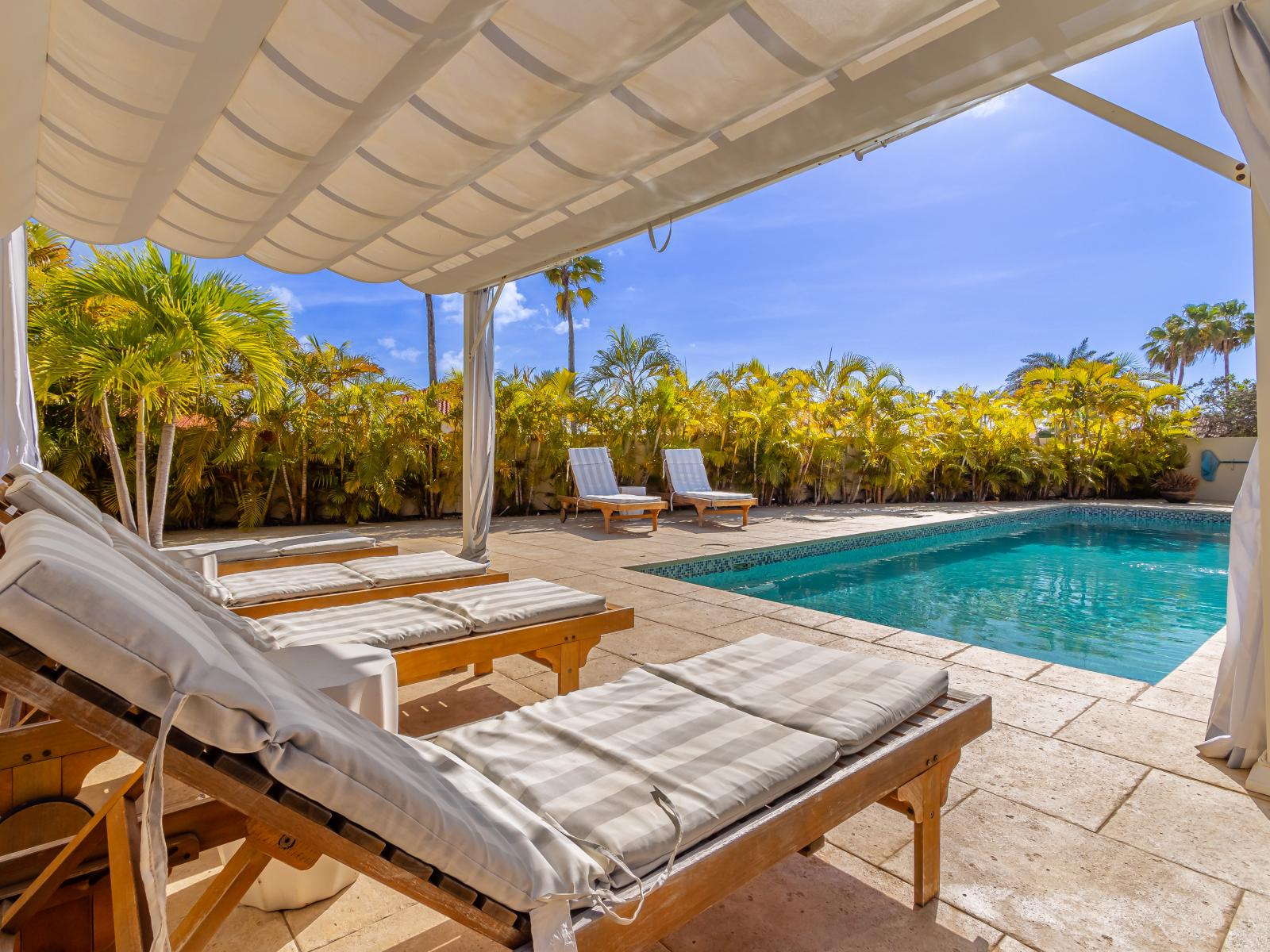 Exclusive pool area with a cozy cabana, ideal for relaxing and enjoying privacy.