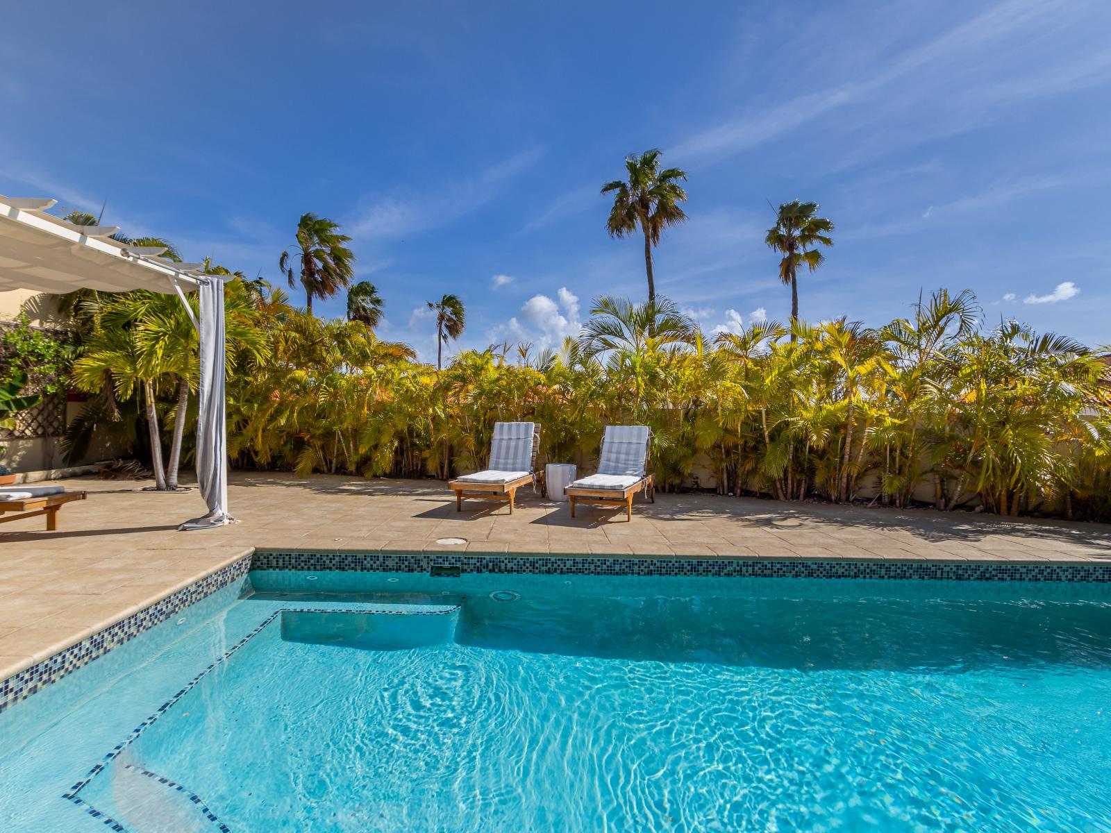 Exclusive pool area with a cozy cabana, ideal for relaxing and enjoying privacy.