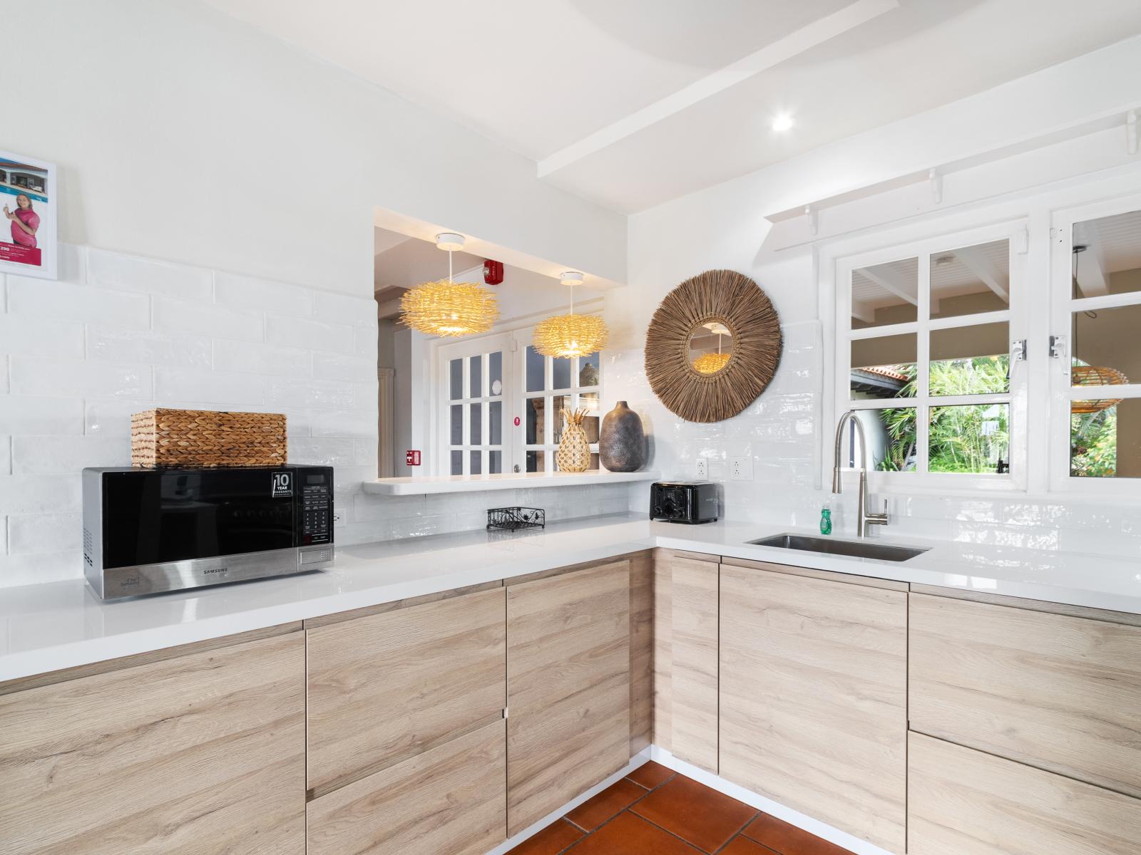 Kitchen has a window that overlooks the backyard and pool