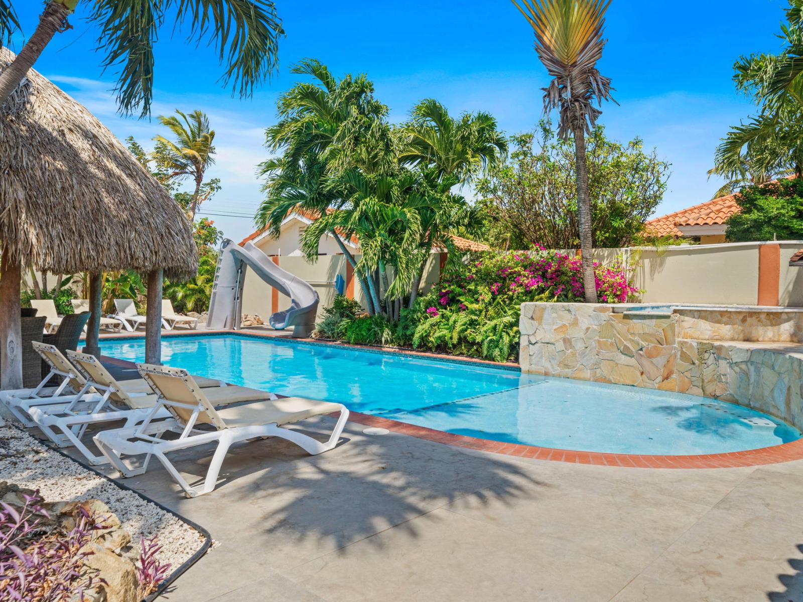 Lots of chairs by the pool for laying in the sun