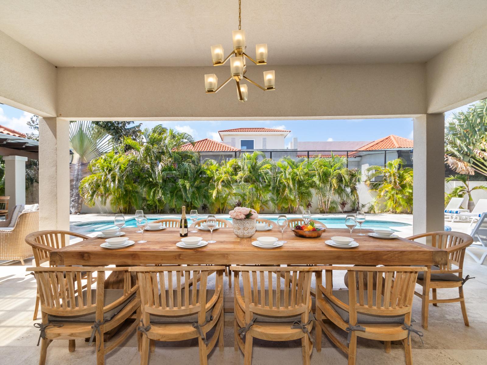 Lavish outside dining area of the Villa in Aruba - 10 Persons Dining - Bite into bliss beneath the stars at outdoor oasis - Elevate your dining experience amidst the beauty of nature - Pool Views