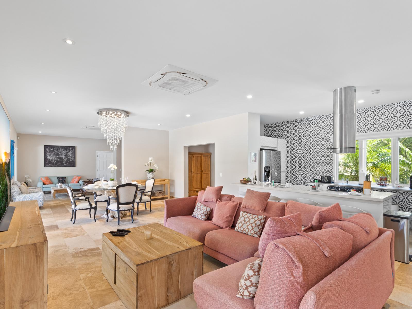 Charming Living and Dining Area of the Villa in Barcelona Spain - Spacious open-plan design for a modern feel - Natural light through large windows - Elegant Decor - Majestic Chandelier