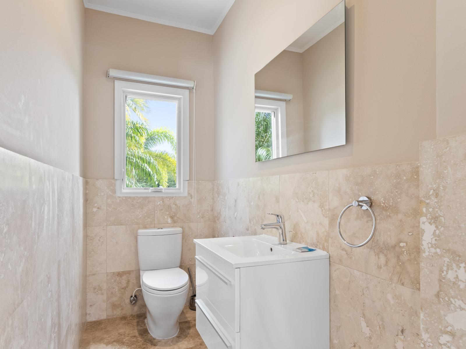 Spacious Bathroom of the Villa in Noord Aruba - Beautiful Vanity with large size wall mirror - Sufficient storage space - Neat and clean toilet seat - Availability of all bathroom amenities