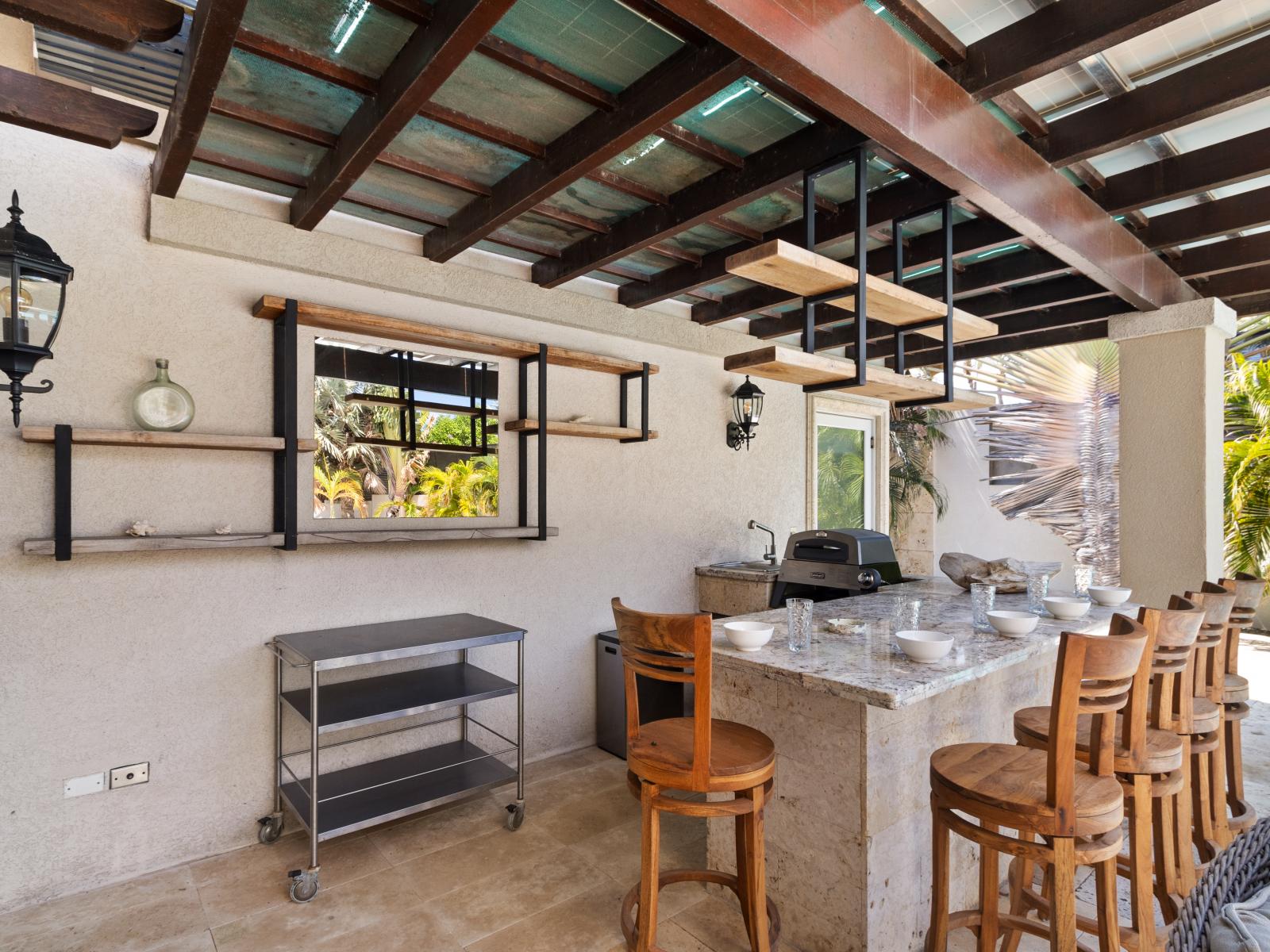 Explore our outdoor kitchen area, designed for preparing meals al fresco in a welcoming and spacious setting.