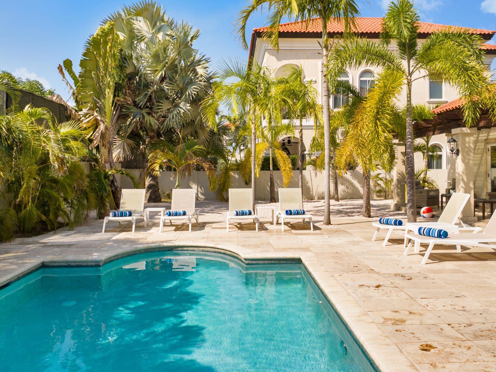 Backyard retreat featuring a pool and lounge chairs for ultimate relaxation.