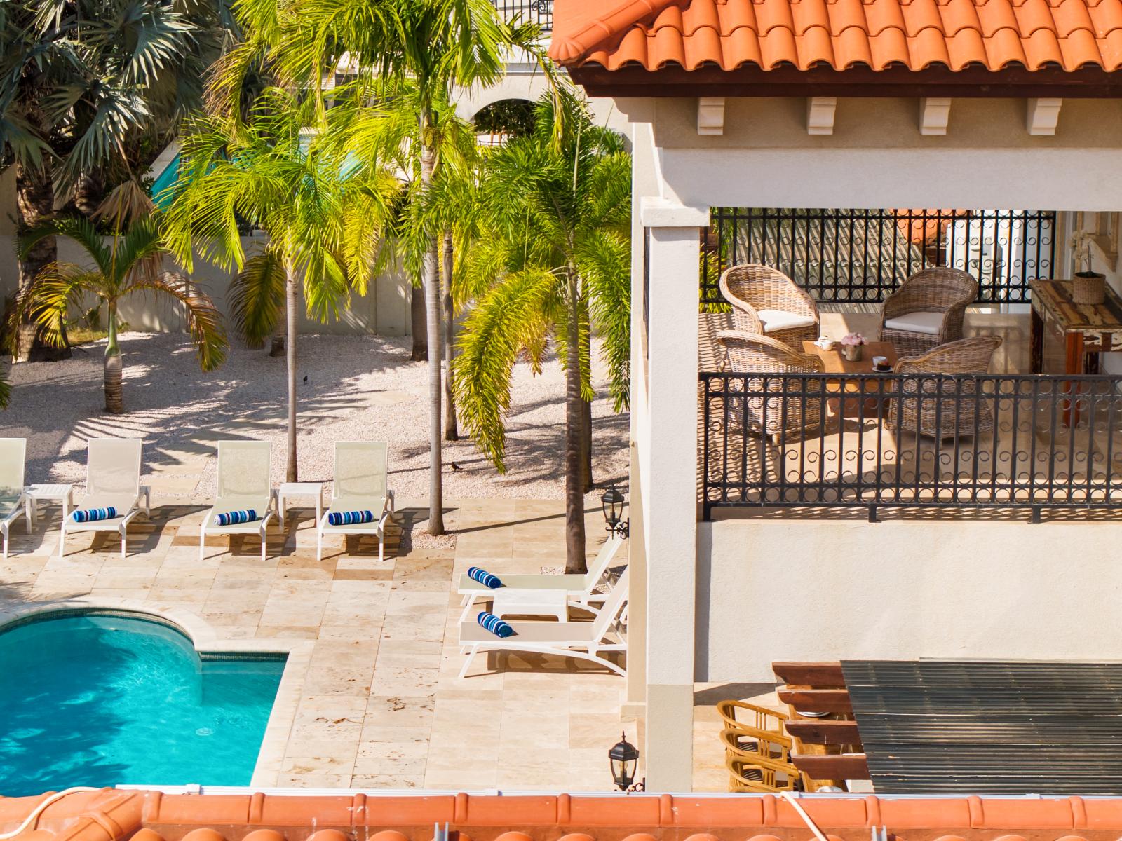 Balcony overlooking the pool, offering a perfect vantage point for relaxation.