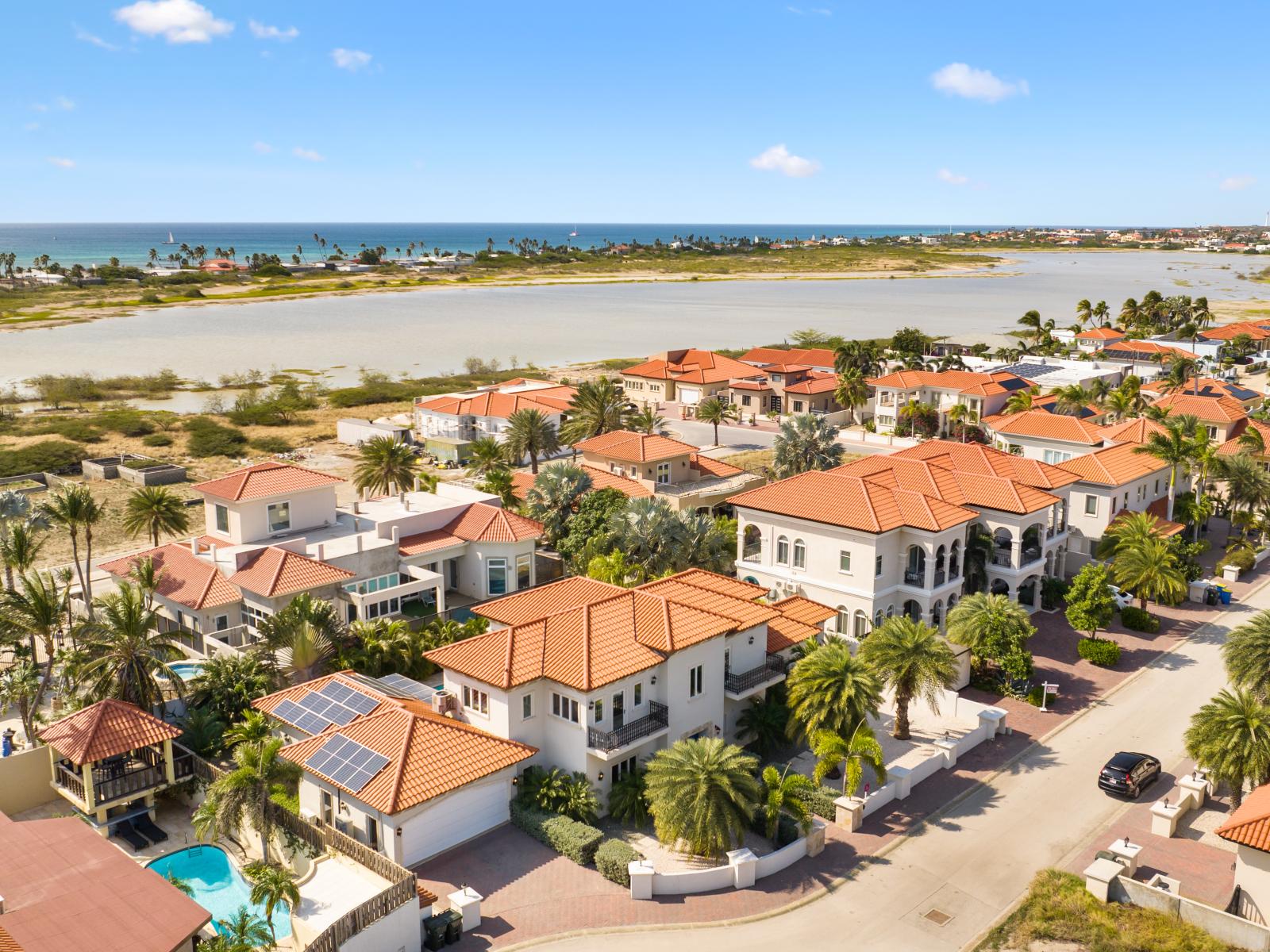 The villa with the beach in the background, blending elegance with coastal beauty.