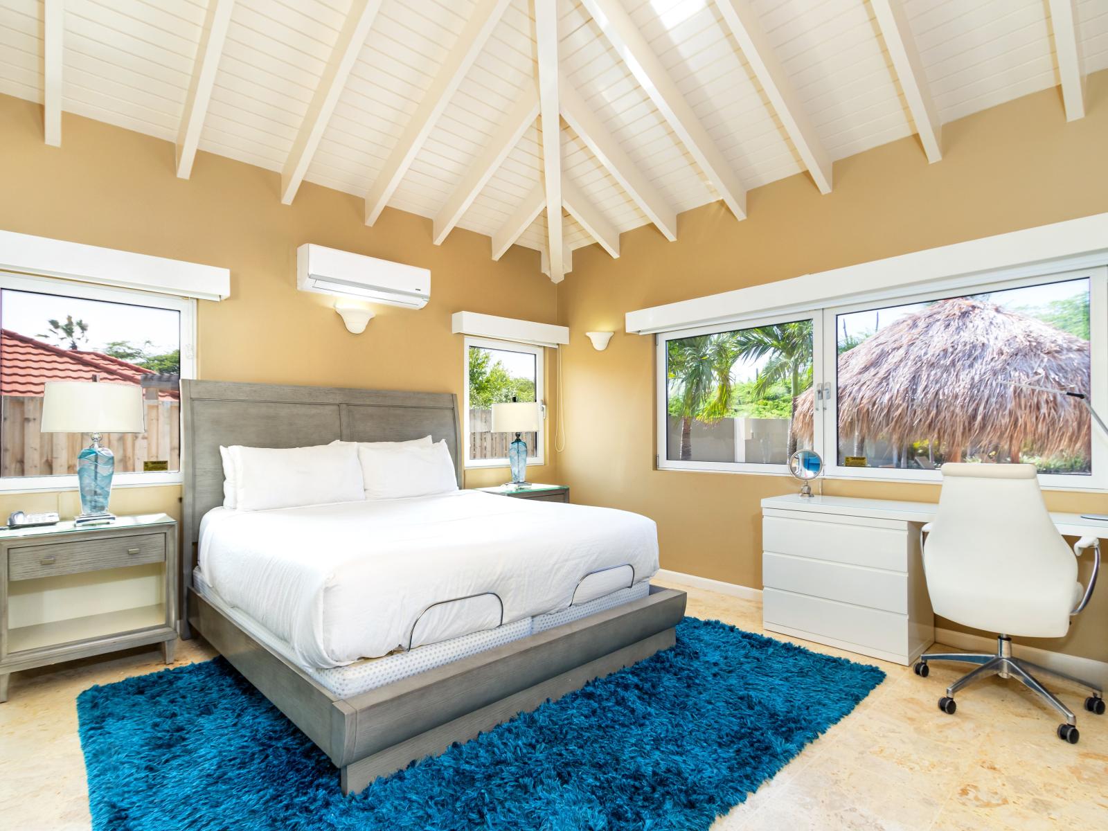 Deluxe Bedroom of the Villa in Noord Aruba - Full King Size Bed - Minimalist decor, creating a clean and uncluttered sleeping space - Cozy retreat with a plush bed, perfect for relaxation - Dedicated workspace