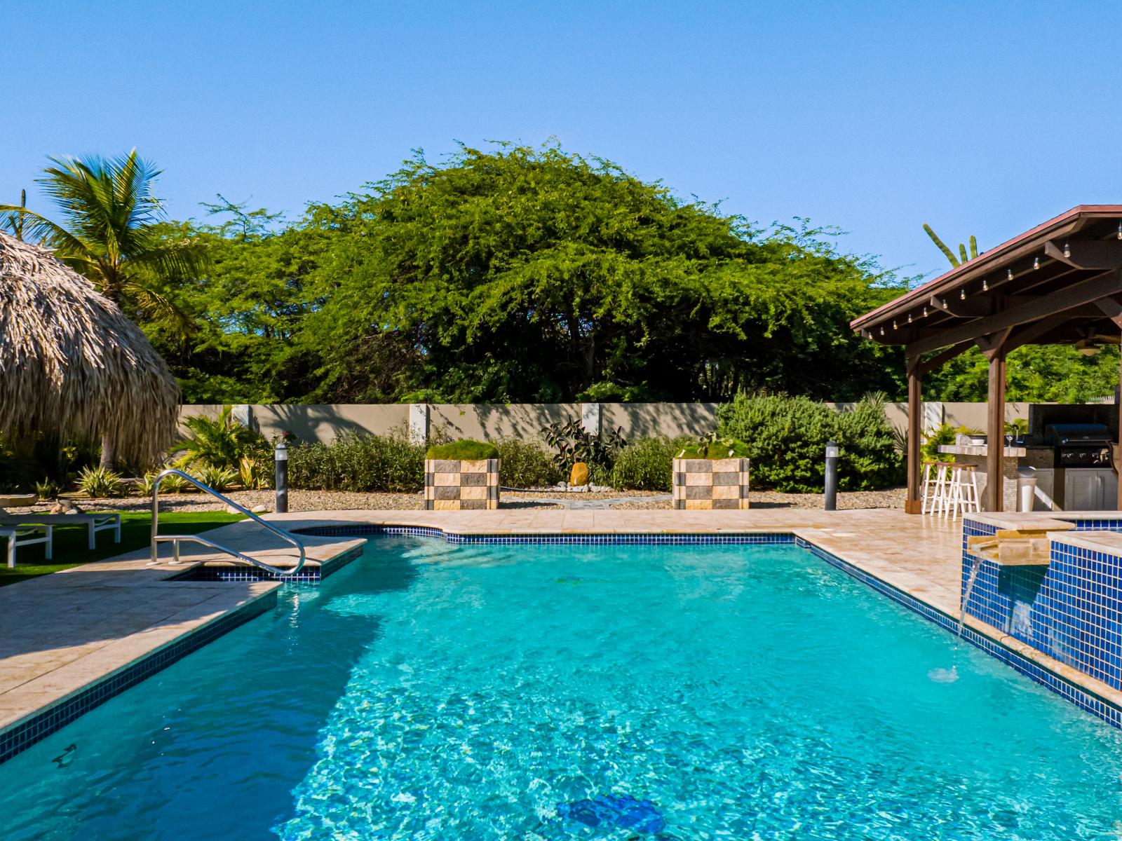 Private Refreshing  Pool Area of the Villa in Noord Aruba -  Scenic space for relaxation - Dive into a refreshing poolside escape - Lounge in tranquility by the sparkling waters